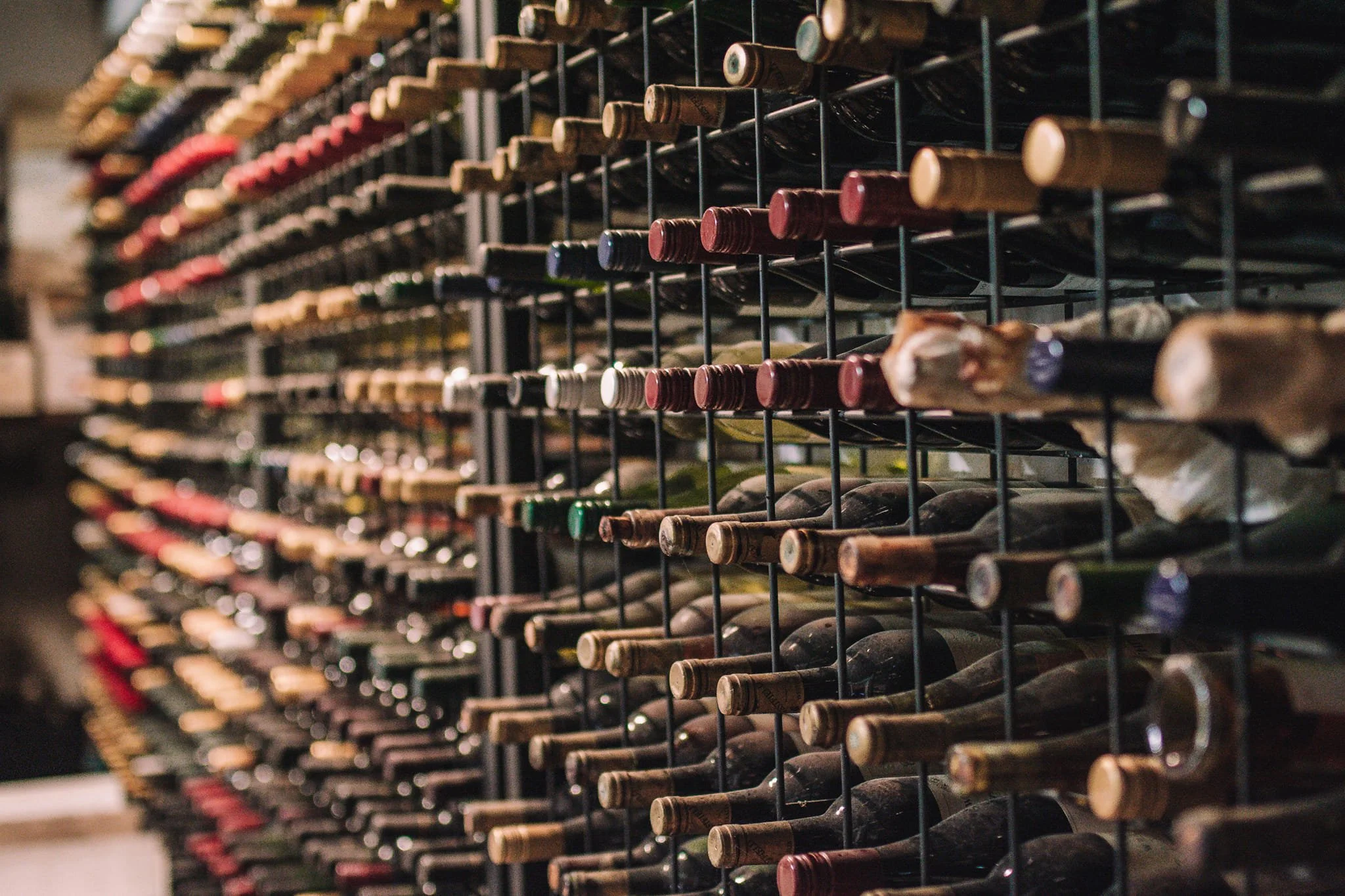 A wine rack filled with bottles of wine stored horizontally.