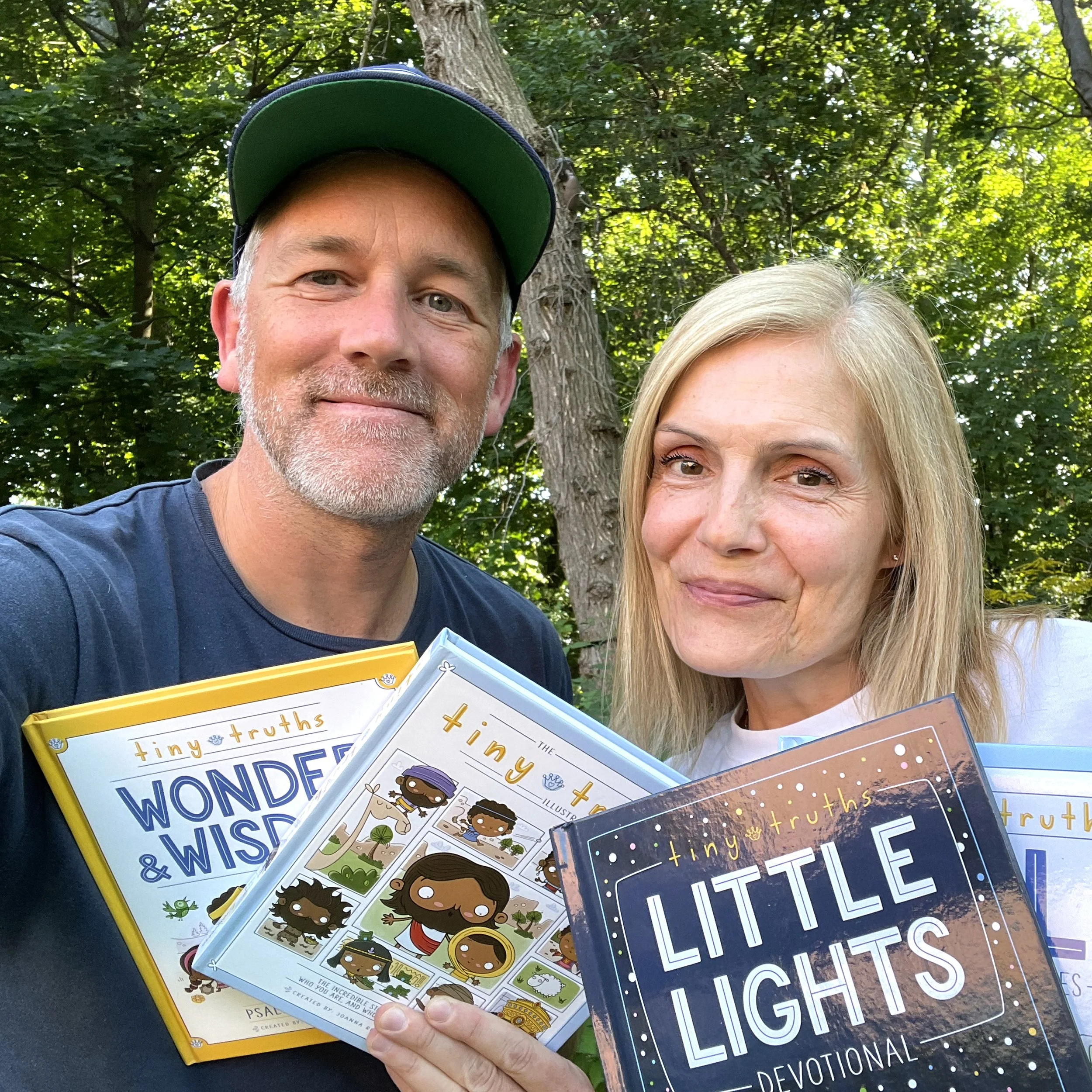 This is a picture of the two creators of tiny truths Tim Penner and Jo Rivard holding up their four books that they published with Zonderkidz