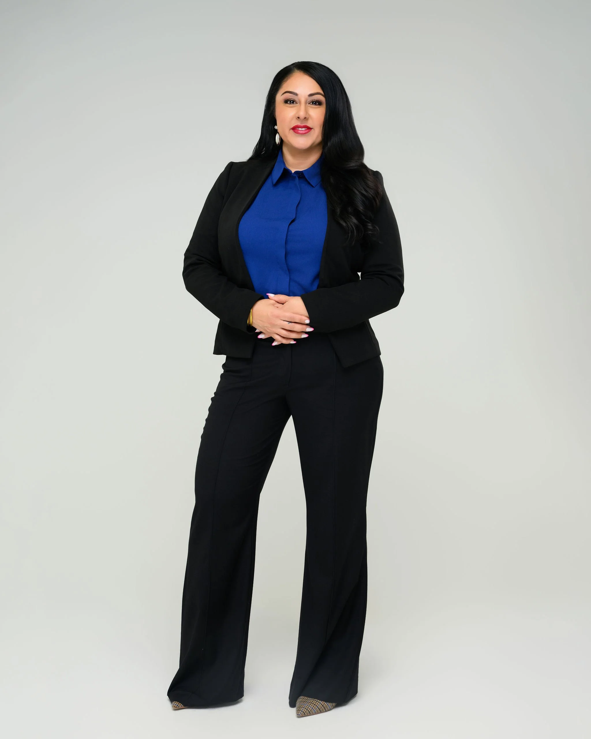 Bianca Santorini standing with a suit and blazer full body shot
