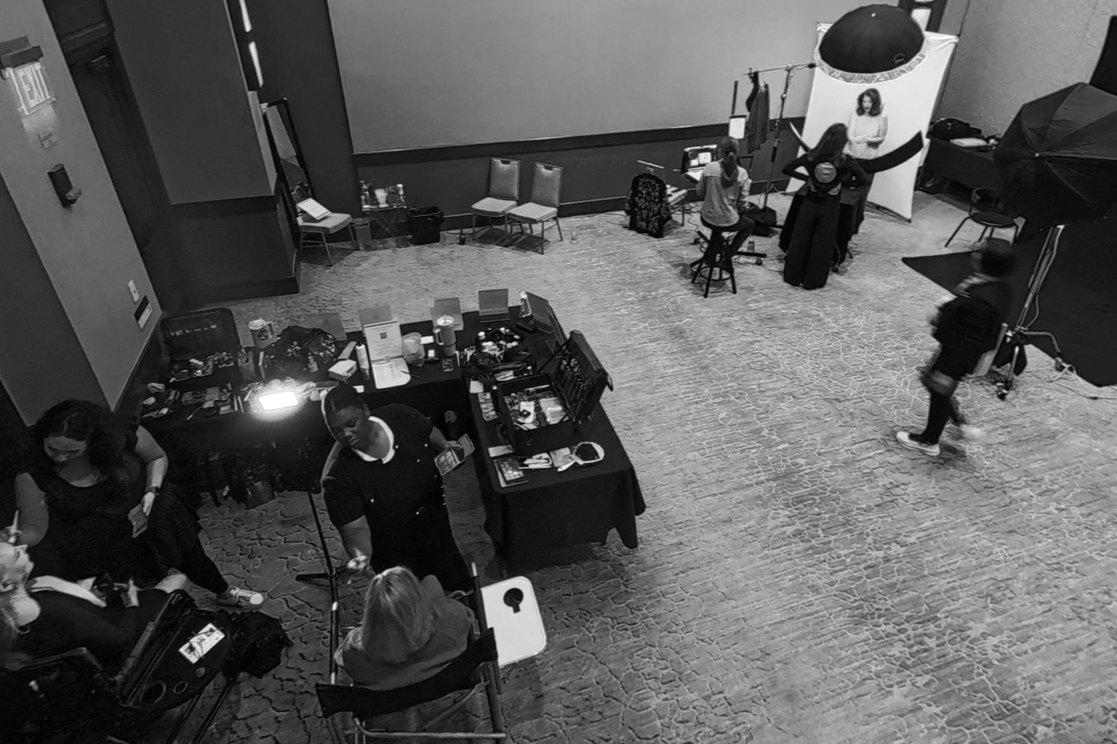 Overhead view of The Portrait Lounge team photographing an attendee during the Extraordinary Women on Boards 2025 event