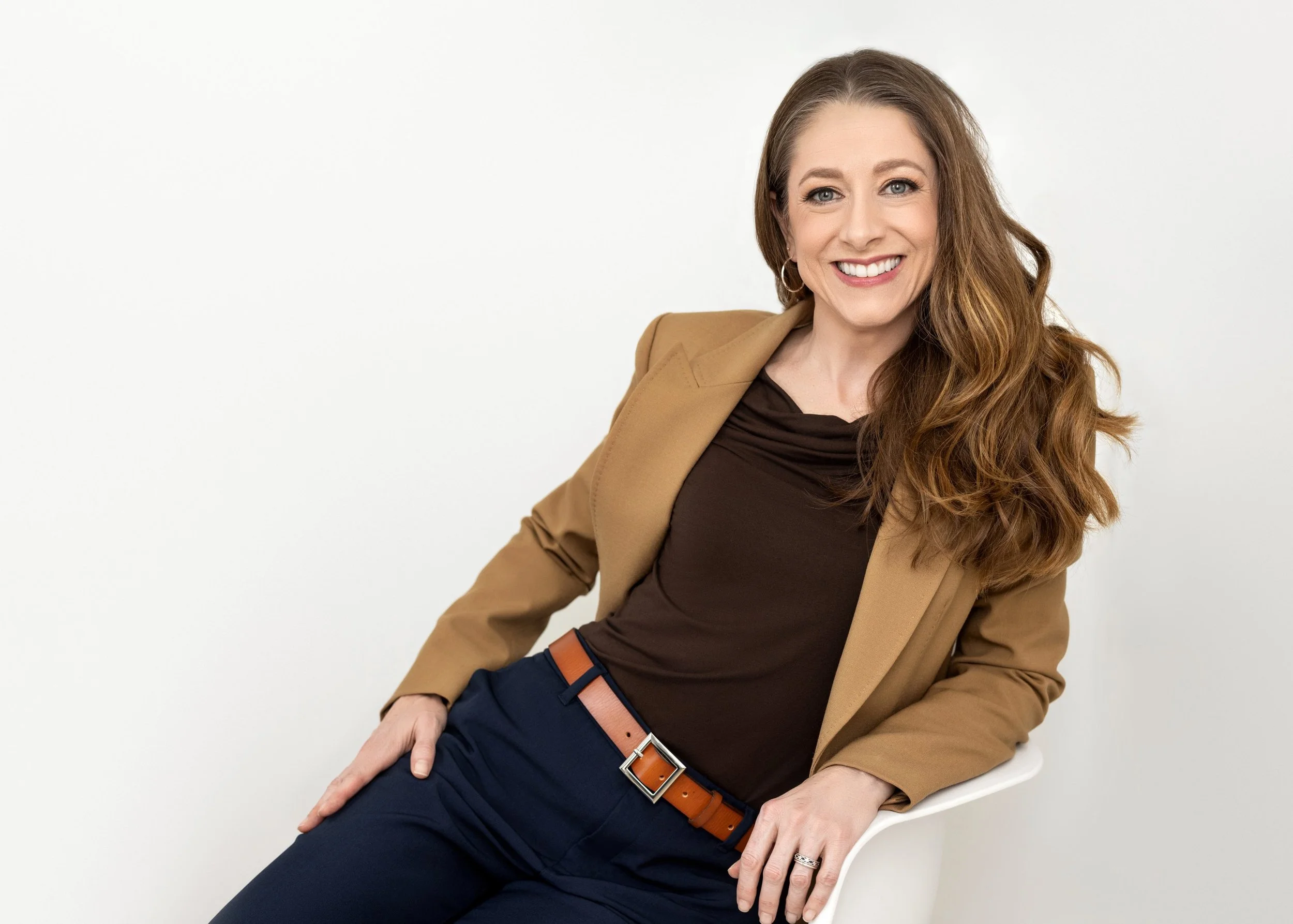Relaxed seated portrait showing a wider composition and alternate pose.