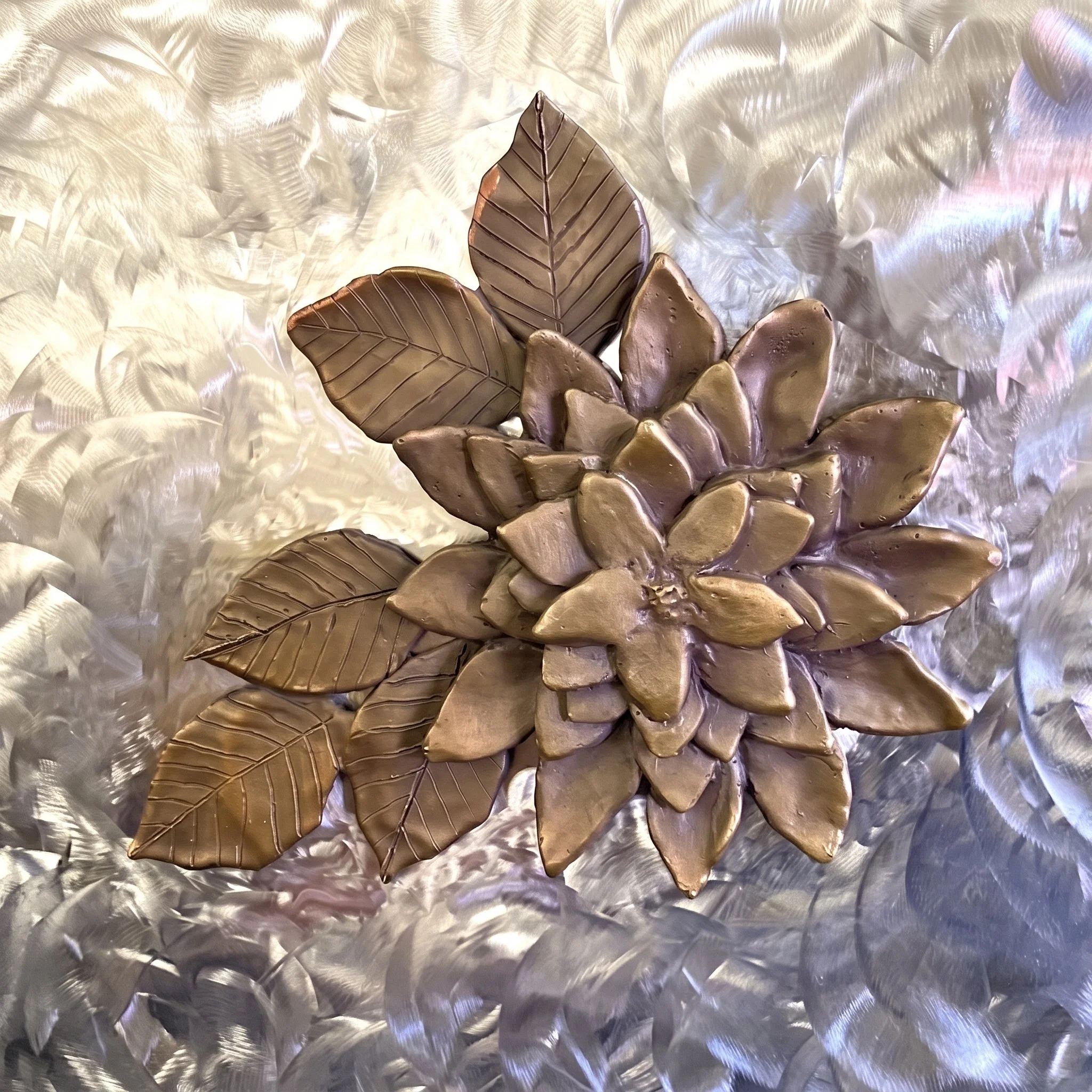 With guidance from sculptor and friend Manuelita Brown, I created seven bronze flowers, and she created the figure and the Kumeyaay Native American Hut in San Diego. "Dahlia" By Judy Salinsky