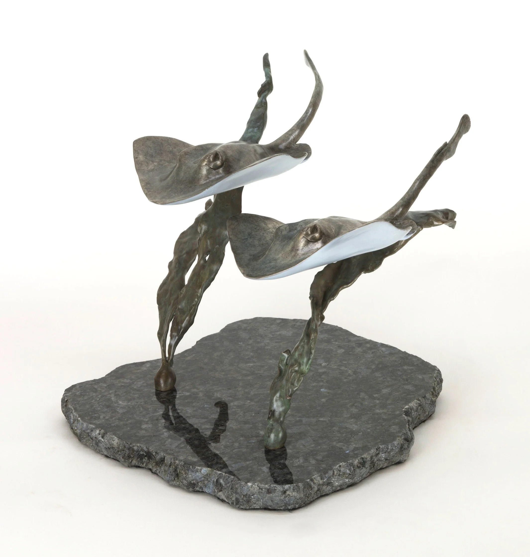 "Two Rays Together" Bronze sculpture of a stingray with extended wings, mounted on a rough stone base. By Judy Salinsky