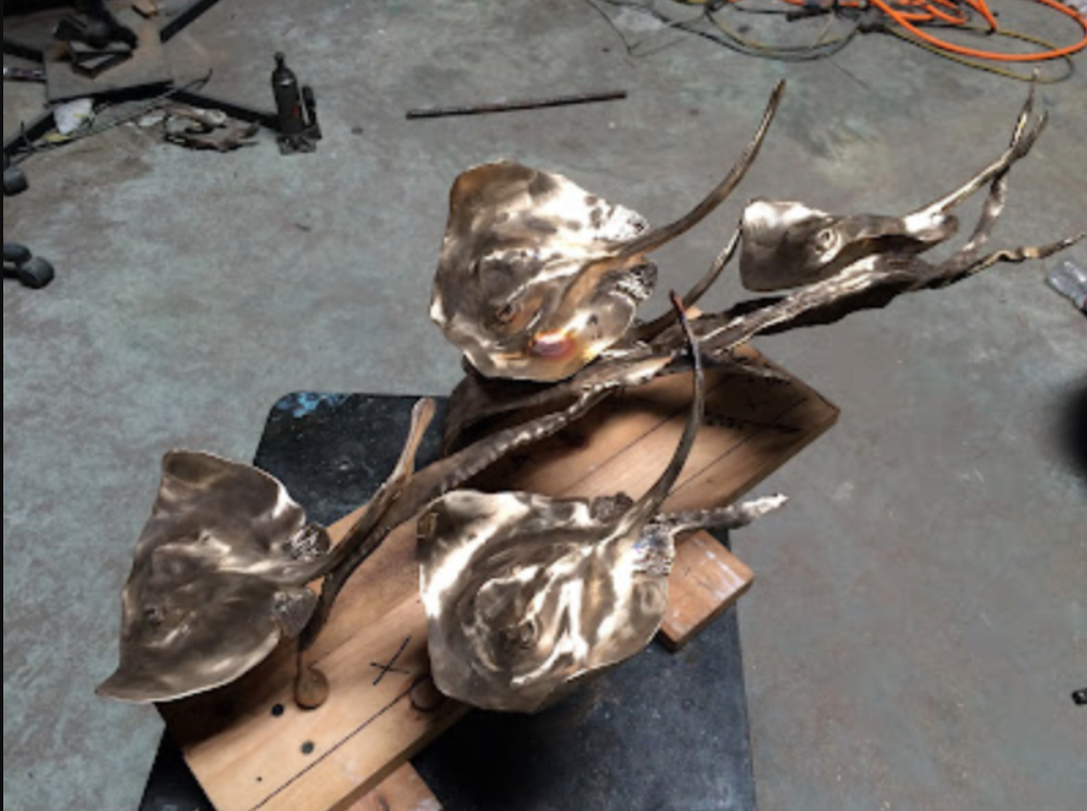 A sculpture made from bronze of multiple stingrays by Judy Salisnky