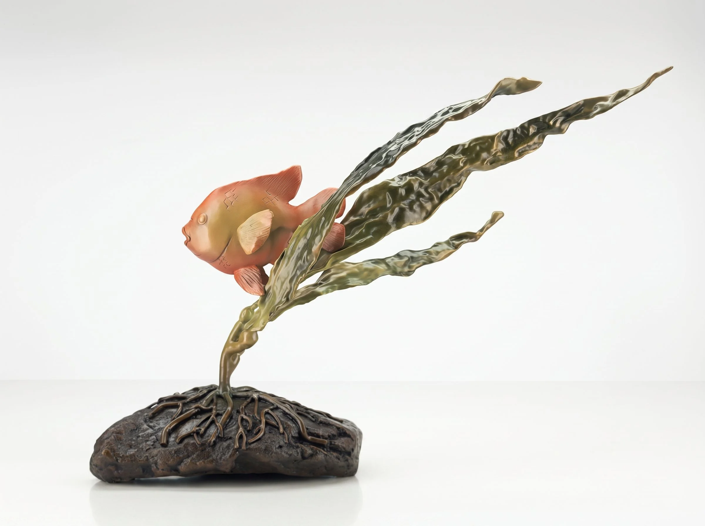Garibaladi Mama, a beautiful sculpture of a fish attached to a metal seaweed-like plant, mounted on a textured rock base.