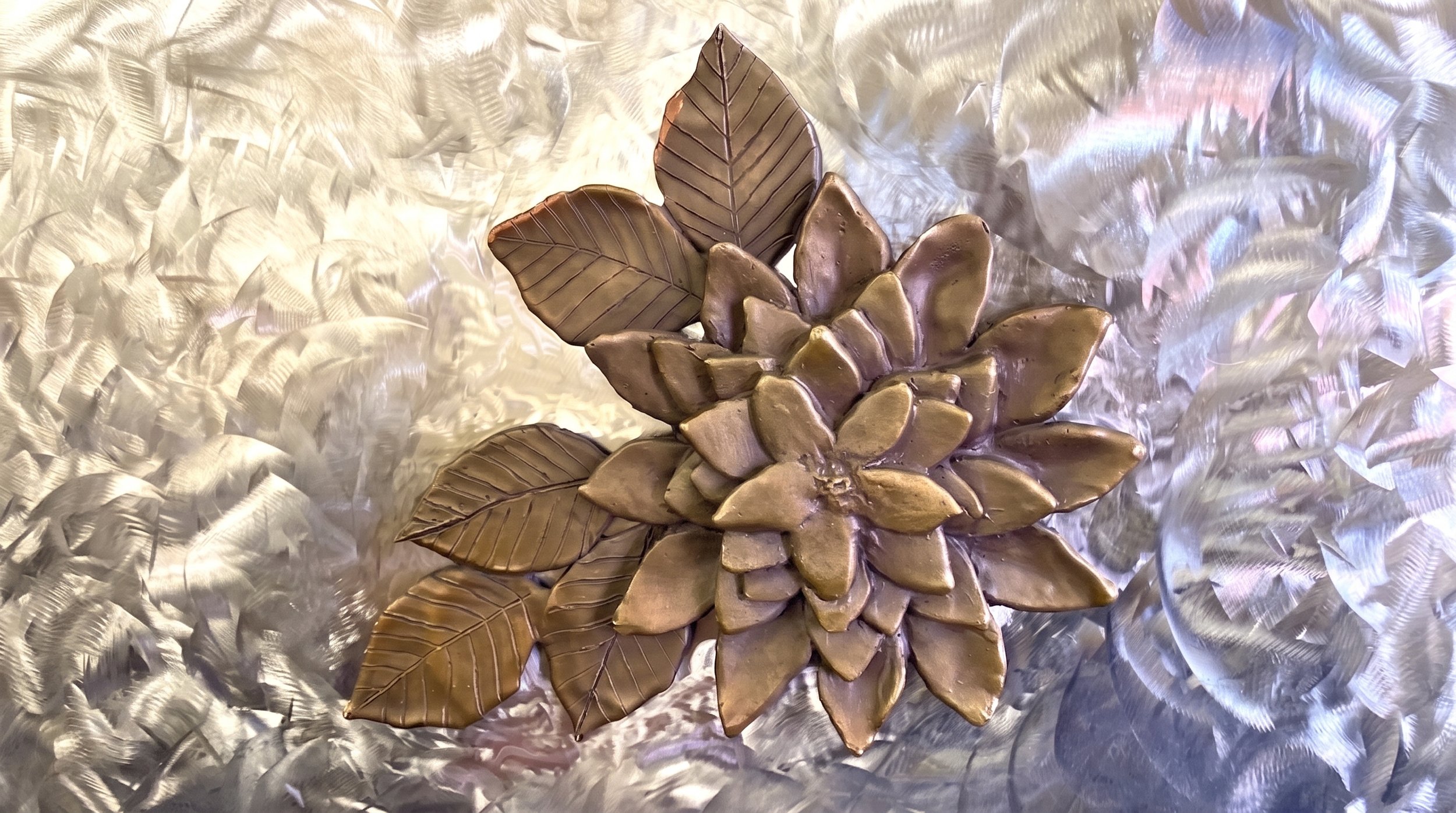 With guidance from sculptor and friend Manuelita Brown, I created seven bronze flowers, and she created the figure and the Kumeyaay Native American Hut in San Diego. "Dahlia" By Judy Salinsky