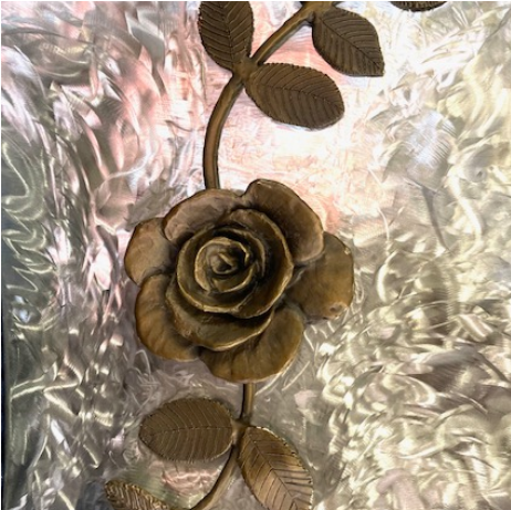 With guidance from sculptor and friend Manuelita Brown, I created seven bronze flowers, and she created the figure and the Kumeyaay Native American Hut in San Diego. "Rose" By Judy Salinsky