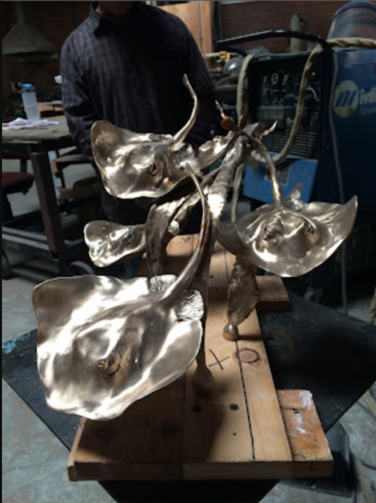 A sculpture made from bronze of multiple stingrays by Judy Salisnky