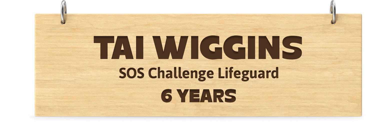 Engraved wooden board. Engraved text: Tai Wiggins SOS Challenge Lifeguard 6 Years