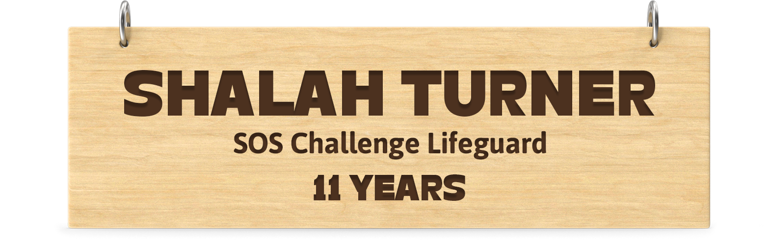 Engraved wooden board. Engraved text: Shalah Turner SOS Challenge Lifeguard 11 Years