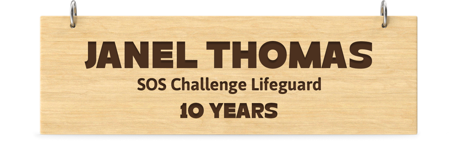 Engraved wooden board. Engraved text: Janel Thomas SOS Challenge Lifeguard 10 Years
