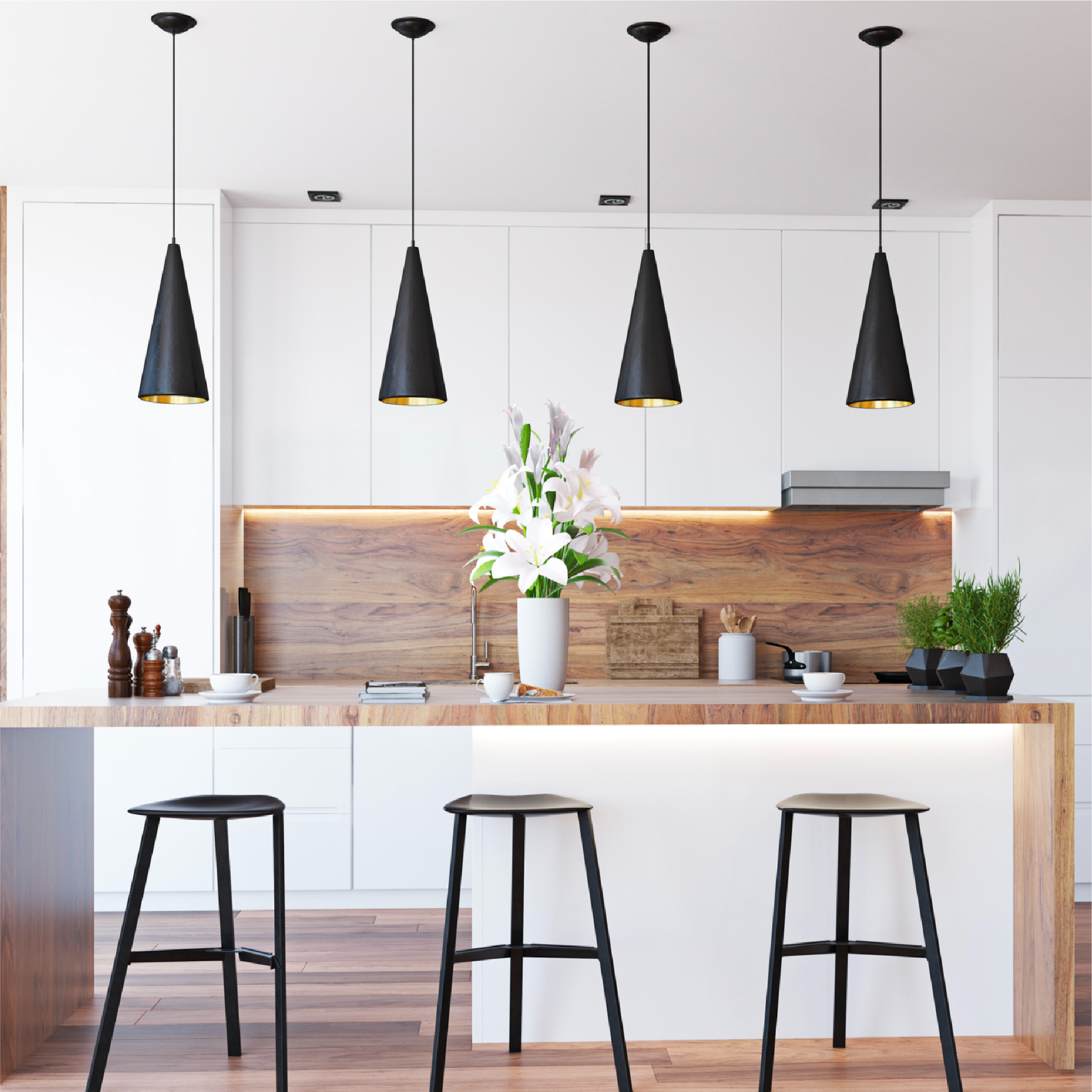 Modern kitchen with a wooden countertop, black bar stools, white cabinets, and black pendant lights hanging from the ceiling.