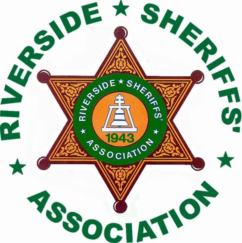 Logo of Riverside Sheriffs' Association featuring a star badge with intricate gold details and a green circular emblem in the center with a cross design, the year 1943, and surrounding text.