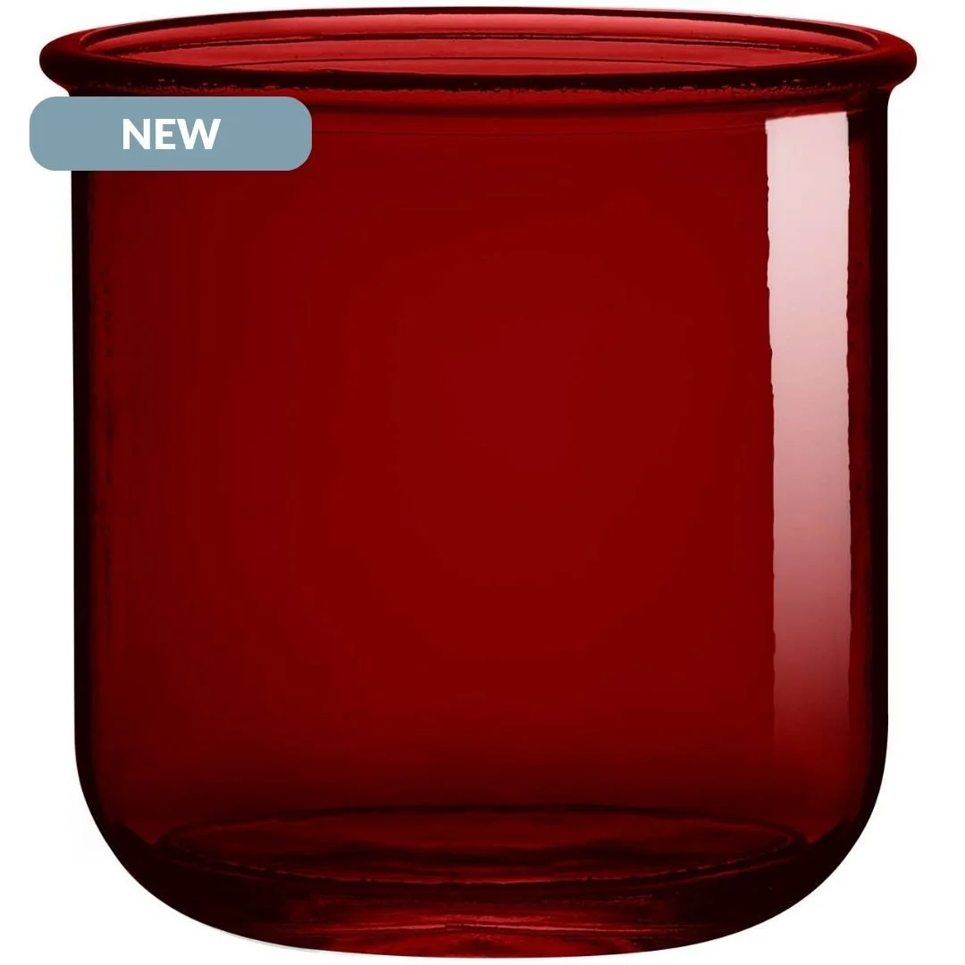 A close-up of a red glass jar or container with a slightly rounded bottom and a wide opening at the top, with a small label on the upper left corner that reads "NEW."