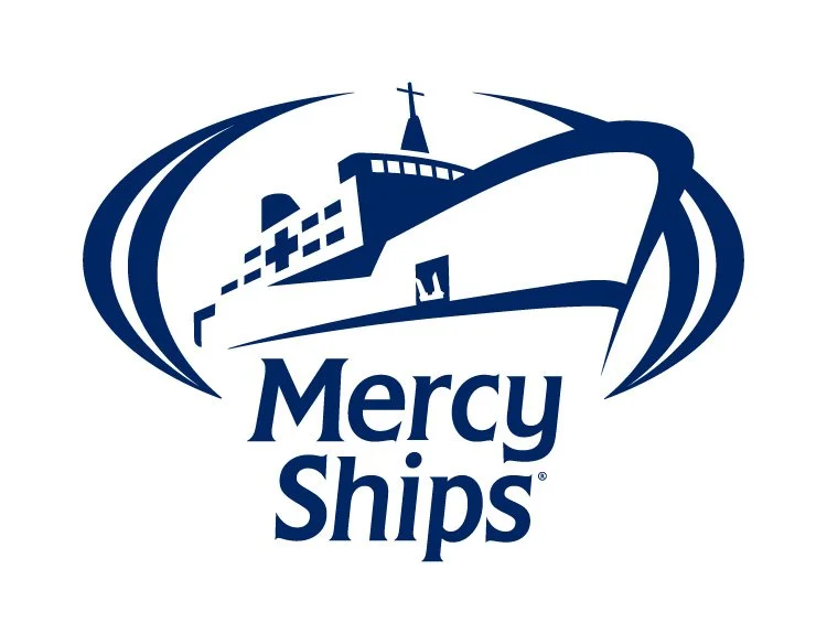 Logo of Mercy Ships showing a blue ship with a cross on top and the words "Mercy Ships" underneath.