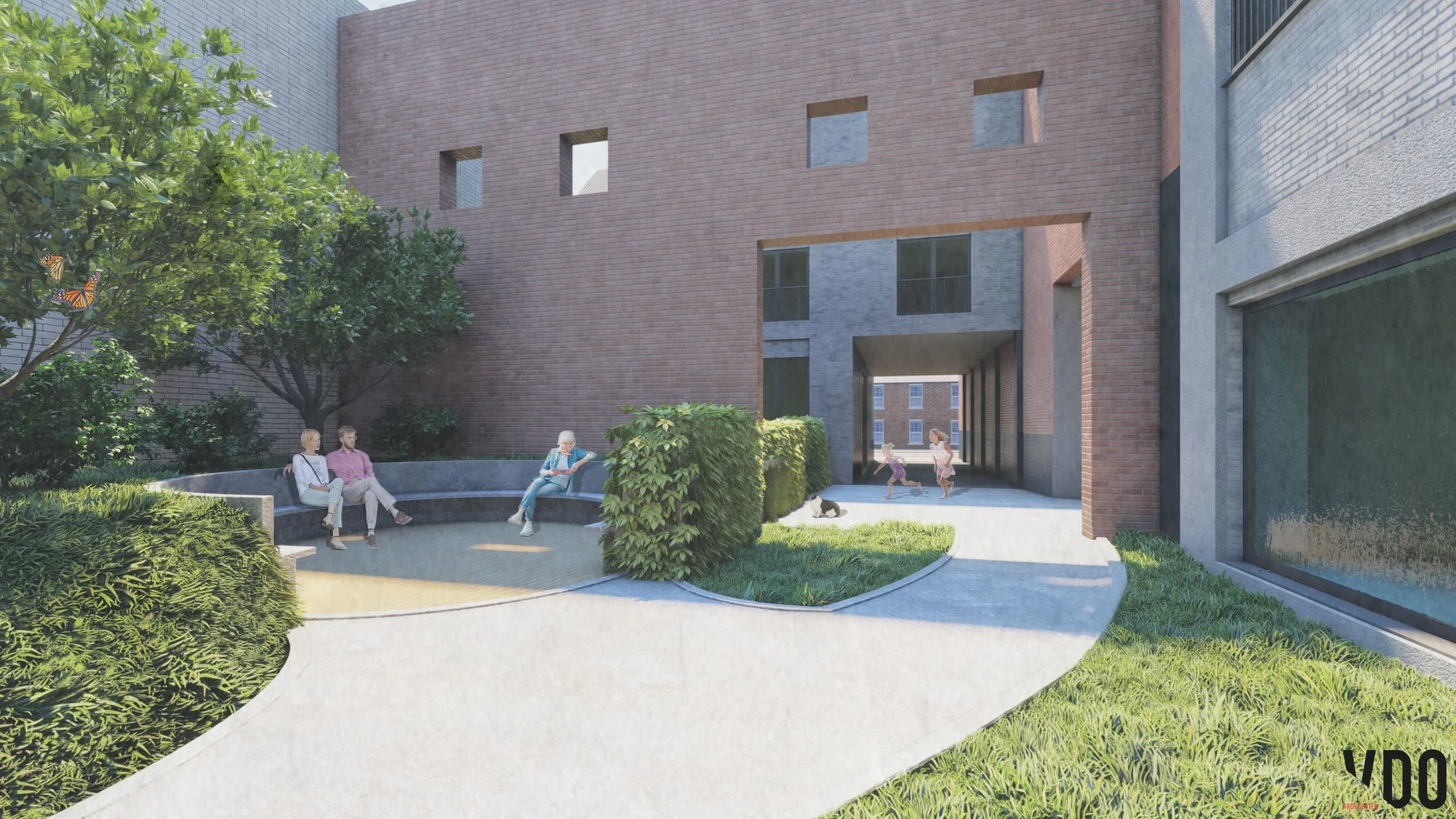 A community courtyard with a curved bench where three people are sitting, surrounded by lush green trees and bushes. Children are playing near an archway in a modern brick building with multiple windows and a covered passageway. A small dog is lying on the ground, and a woman is sitting on the bench reading.