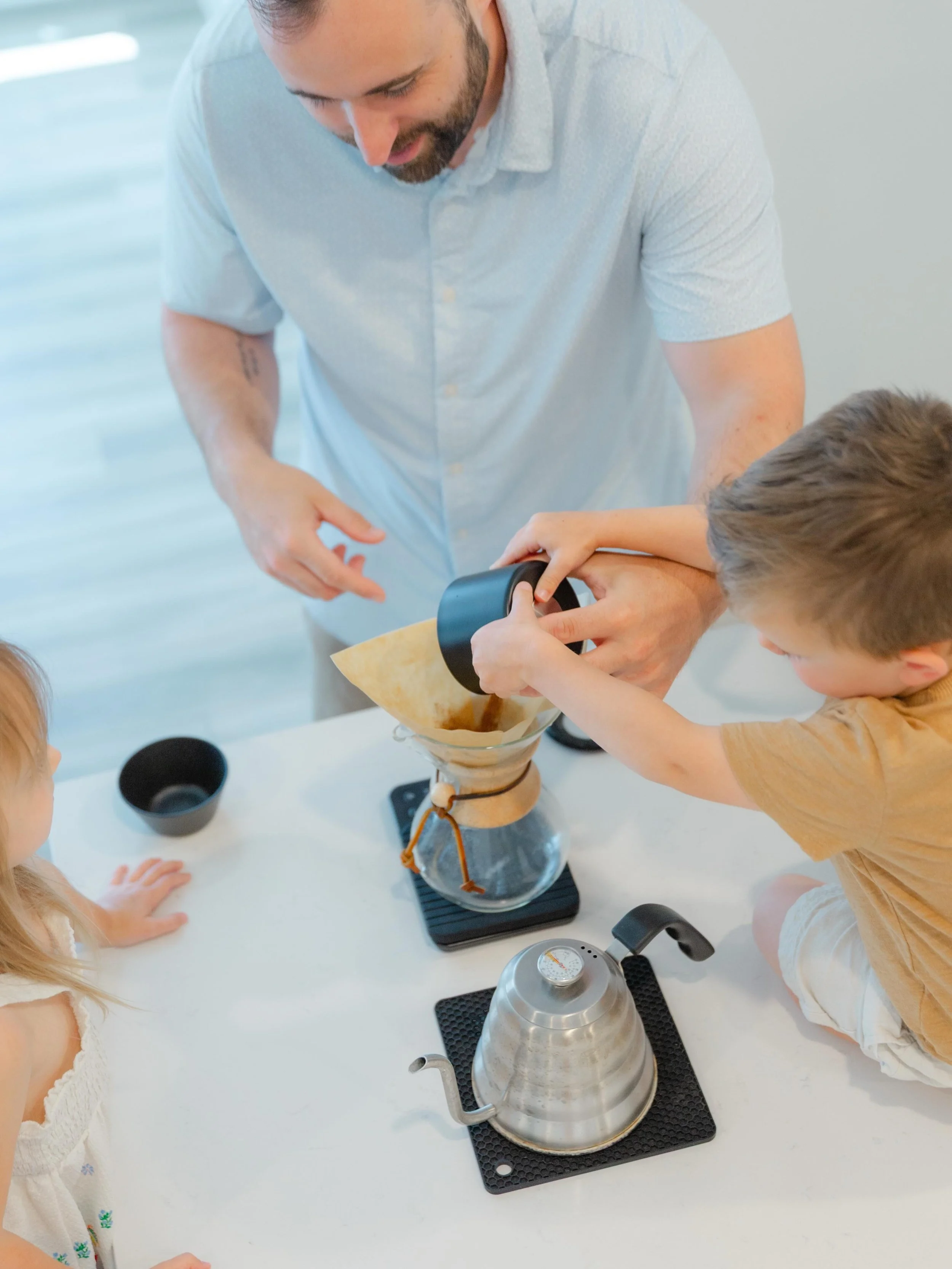 The beauty of family photos isn&rsquo;t found in perfect poses, it&rsquo;s found in moments like these.

Years from now, they won&rsquo;t remember every toy or every busy day.

But they might remember standing on the counter, helping Dad make coffee,