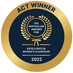 Gold and black badge with text indicating 'Act Winner 2022, The Australian Awards for Excellence in Women's Leadership'.