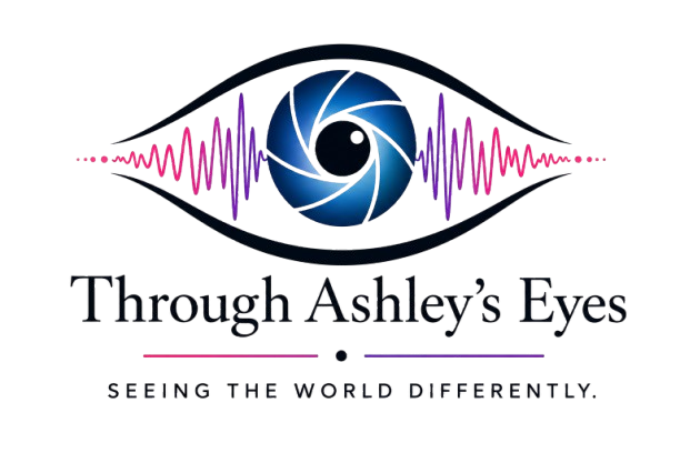 Through Ashley's Eyes logo featuring a stylized eye with a camera lens iris, pink and purple sound waves, and the text "Through Ashley's Eyes" with the tagline "Seeing the World Differently."