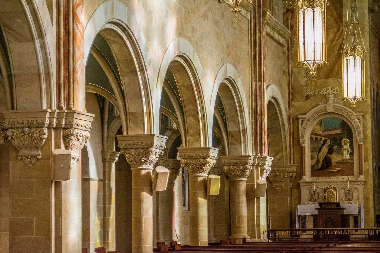 Photograph by Ashley Whitt of the interior of the Basilica at Holy Hill National Shrine of Mary, Help of Christians in Hubertus, Wisconsin, featuring soaring vaulted ceilings, arched windows, ornate columns, and religious artwork.