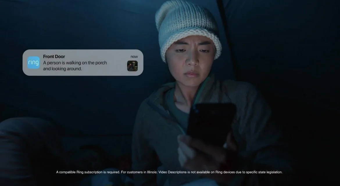 Photo still of Candyce Ha in Ring Camera commercial reacting to Ring phone app notification.