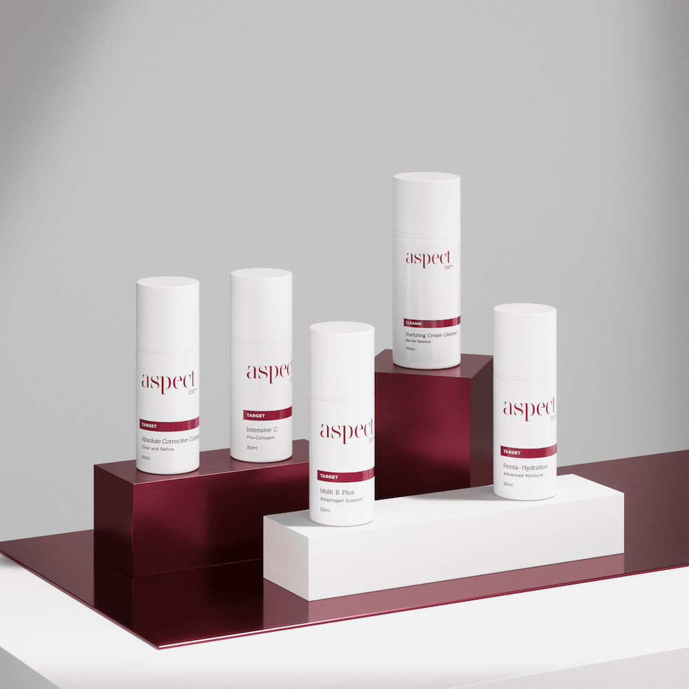 Set of skincare products from the brand Aspect placed on red and white display stands.