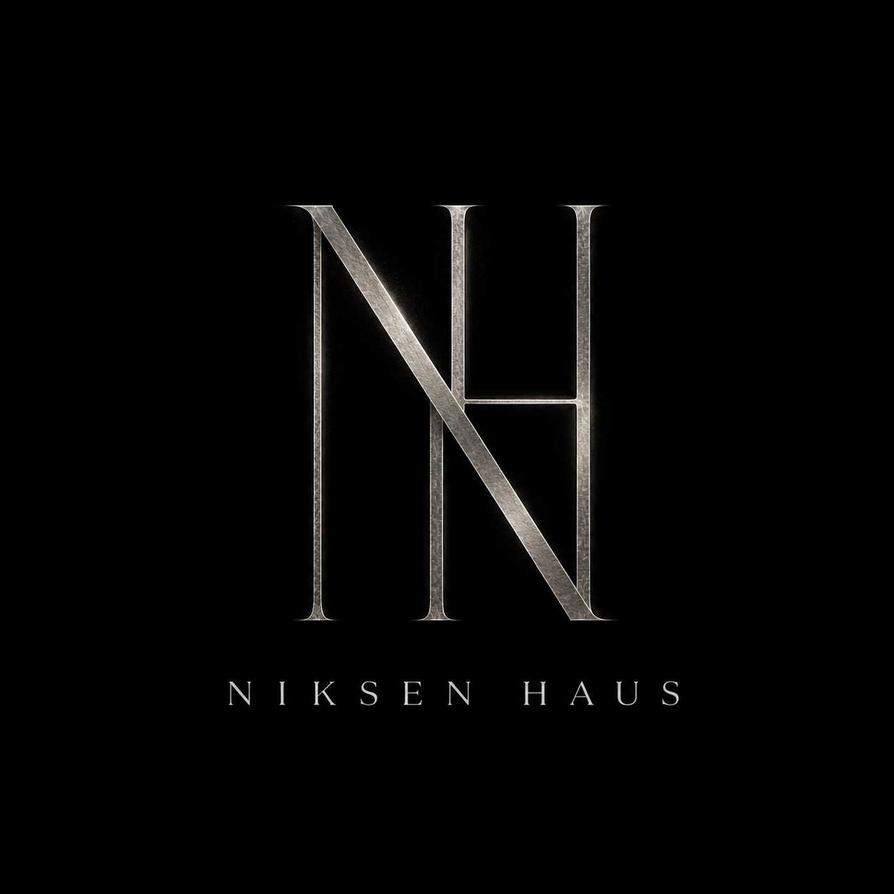 Dark background with a metallic layered logo of the initials N and H, with the name NIKSEN HAUS written below in smaller text.