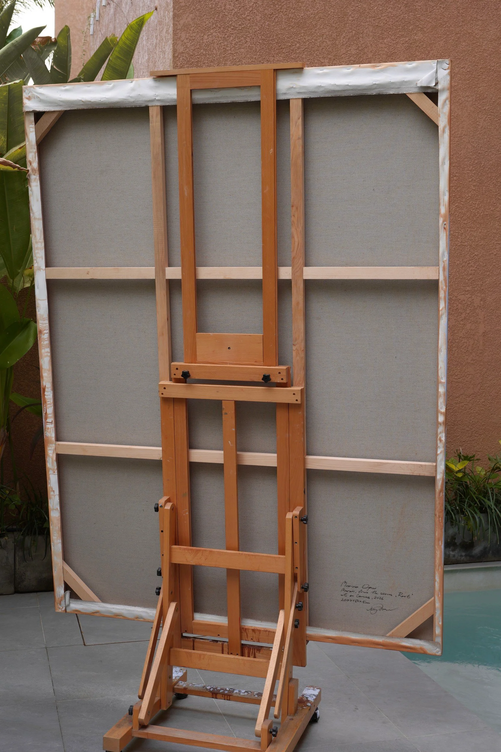 Moran – the back of the 200 × 150 cm canvas on the studio easel, showing the wooden stretcher