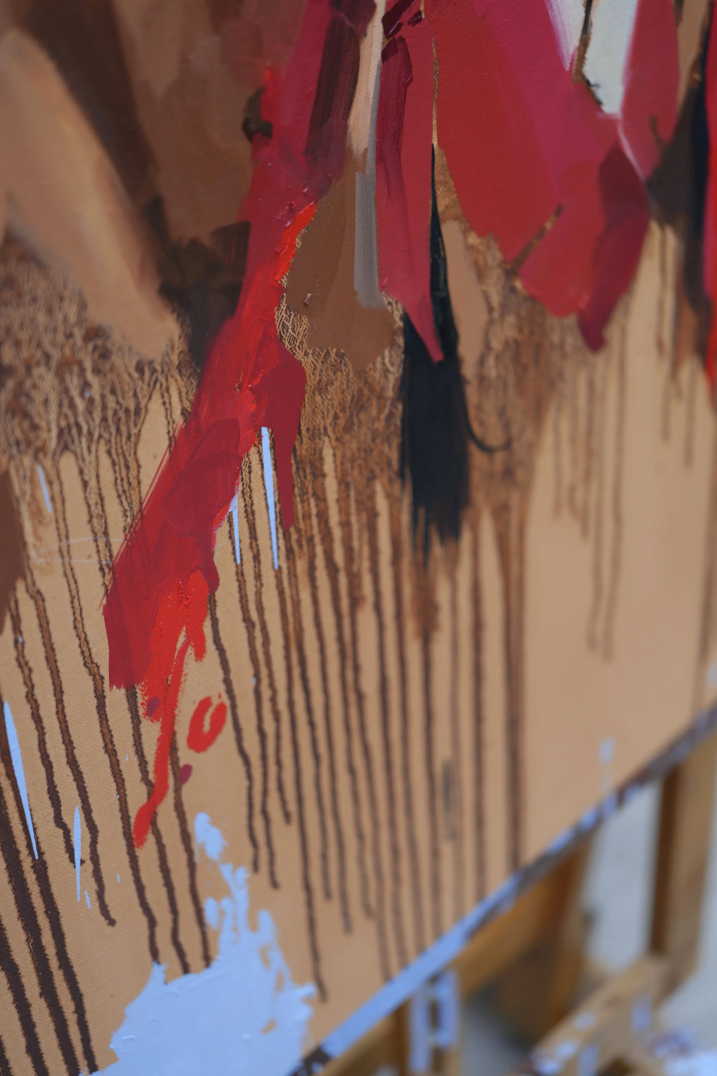 Ochre and red paint drips running down to the canvas edge – detail of The Aftermath by Marina Ogai