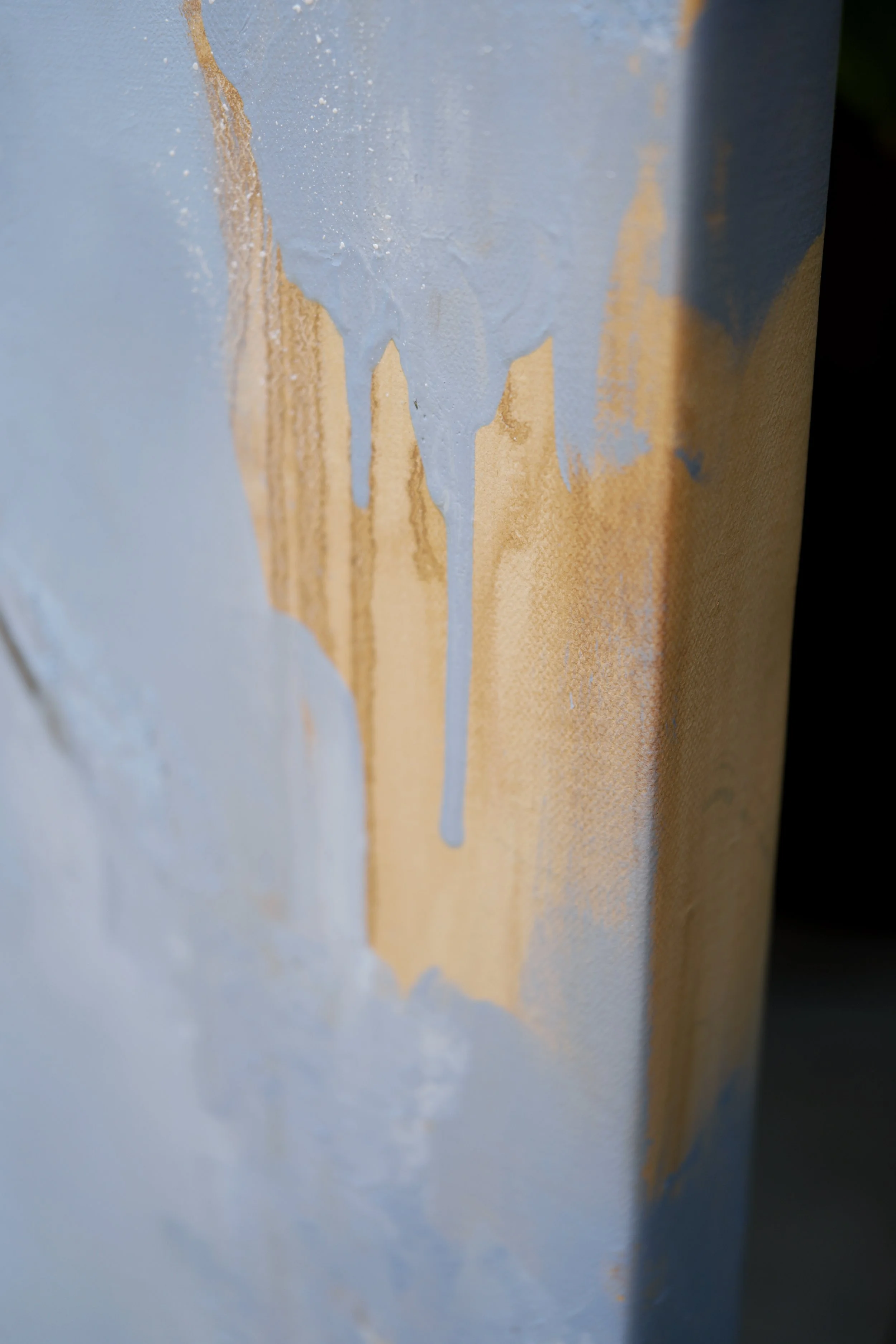 10. Side edge of the canvas with thick ochre drips over blue, paint texture detail of Ground by Marina Ogai