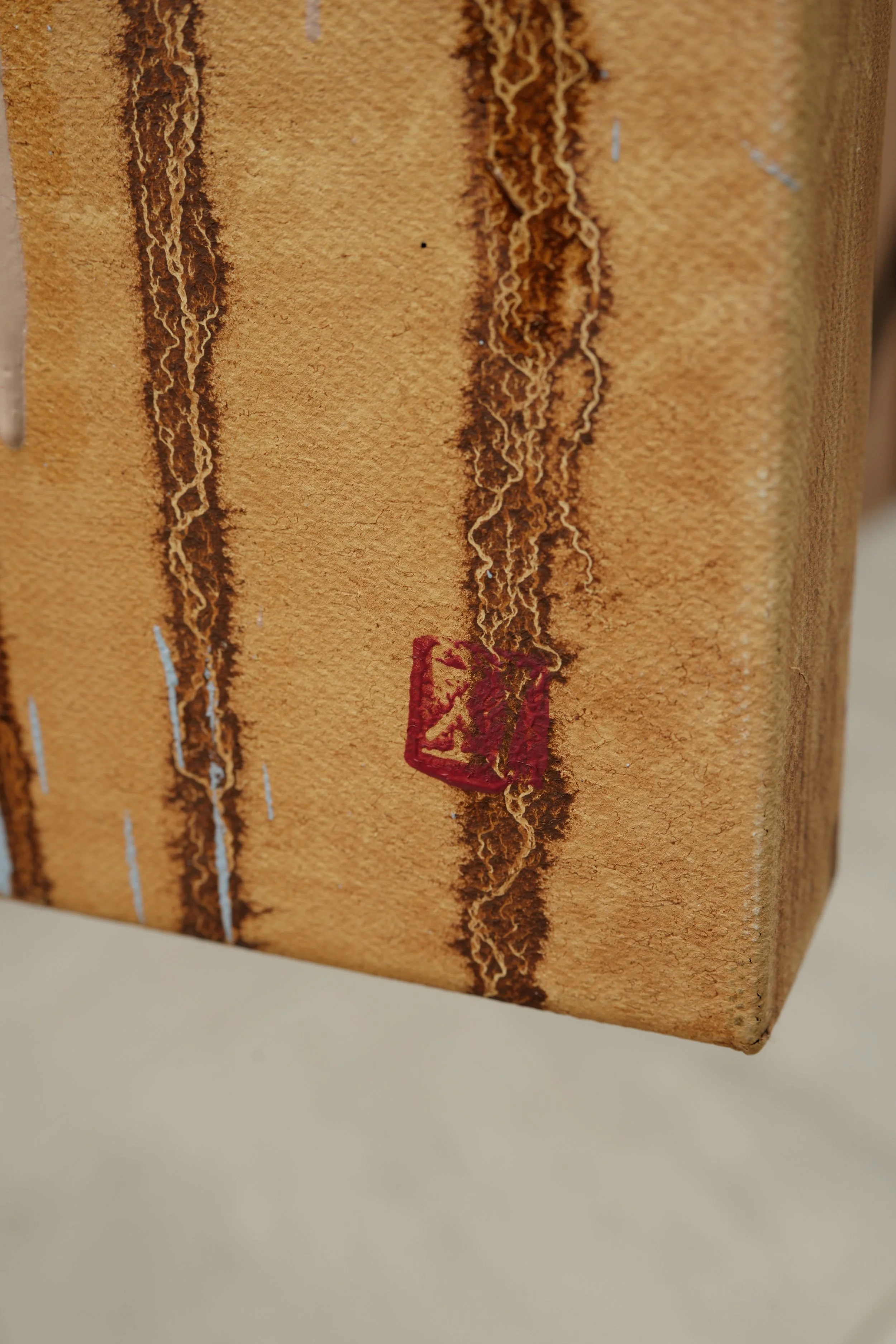 Side edge of the canvas, raw linen with brown paint drips and a red mark, The Encounter by Marina Ogai