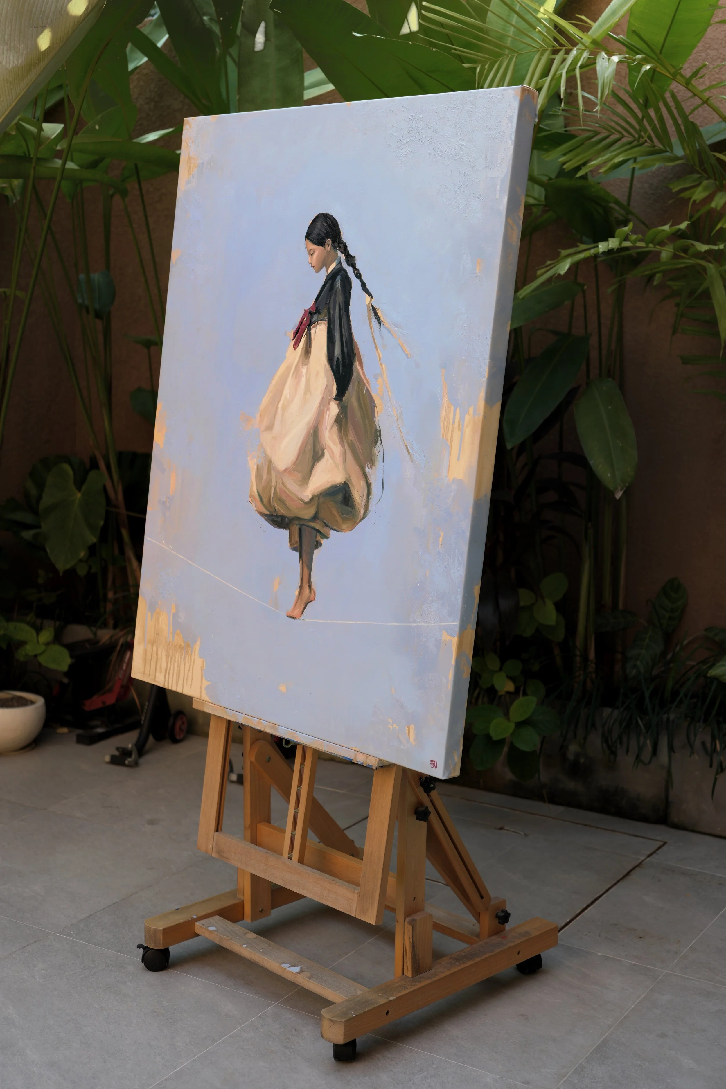 2. The oil painting Ground on an easel in a plant-filled outdoor studio, a figure in hanbok against pale blue, from Given by Marina Ogai