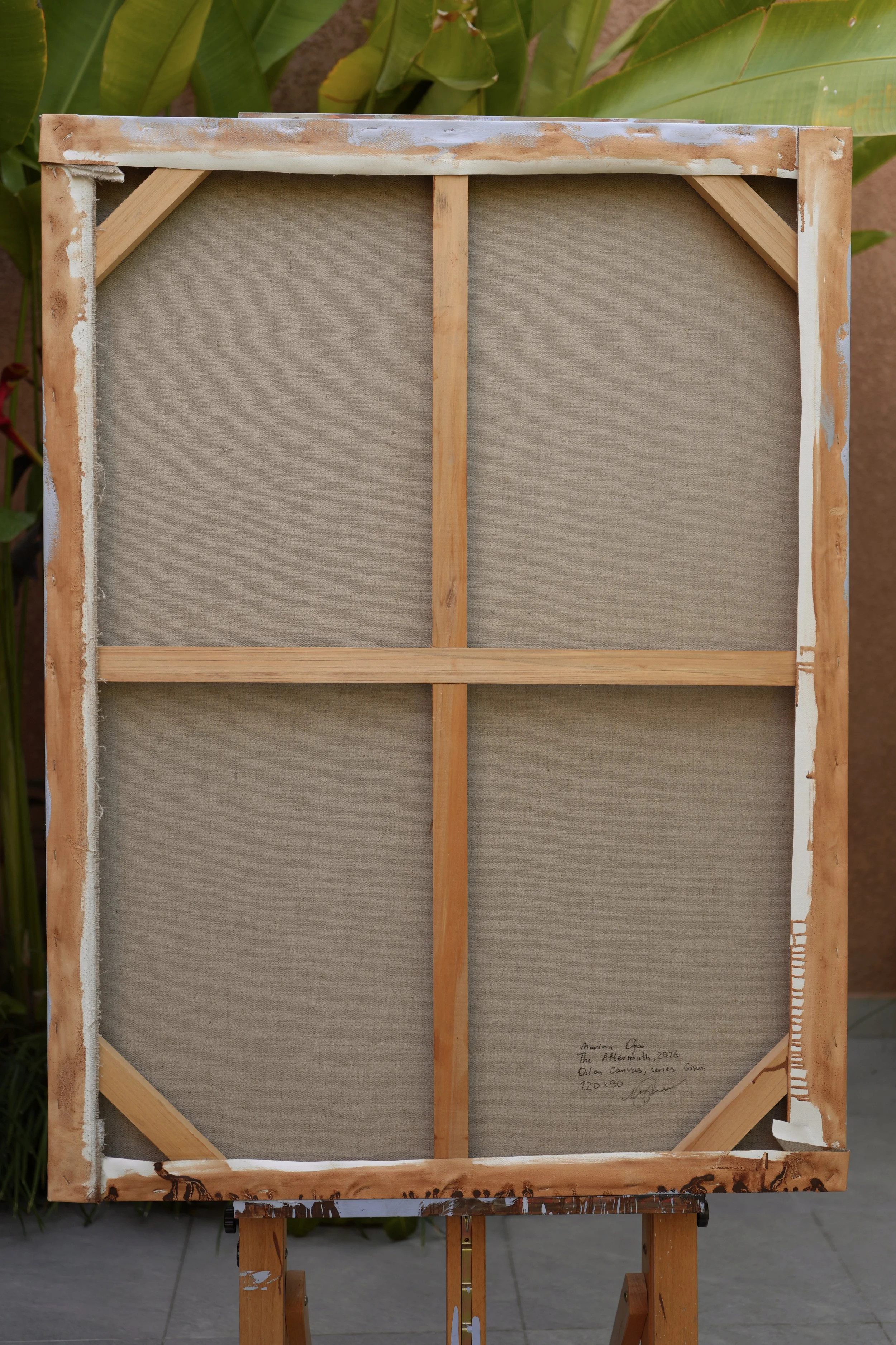 Back of the canvas with wooden stretcher and handwritten inscription – The Aftermath by Marina Ogai