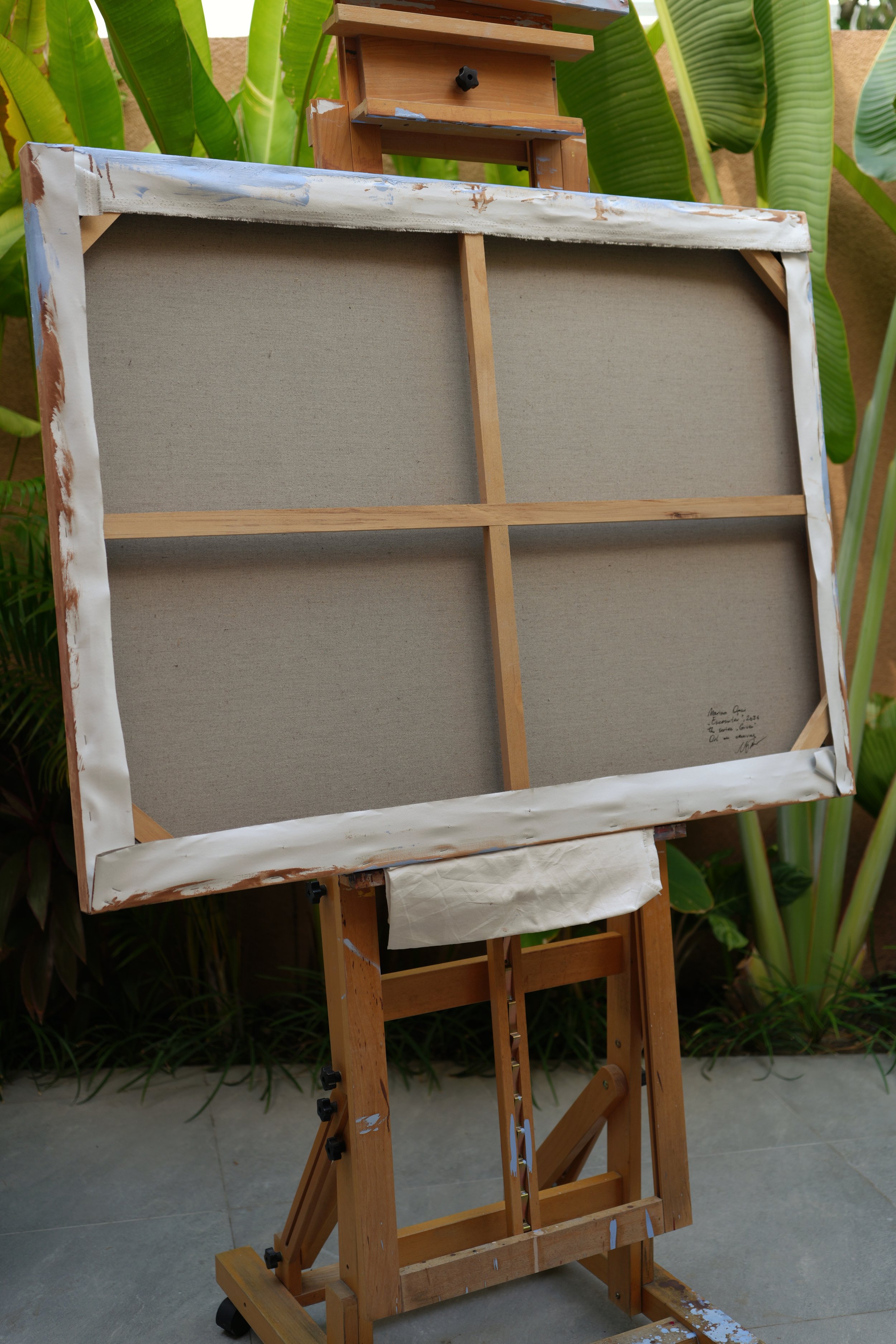 Back of the canvas on an easel, bare linen and wooden stretcher bars, The Encounter by Marina Ogai
