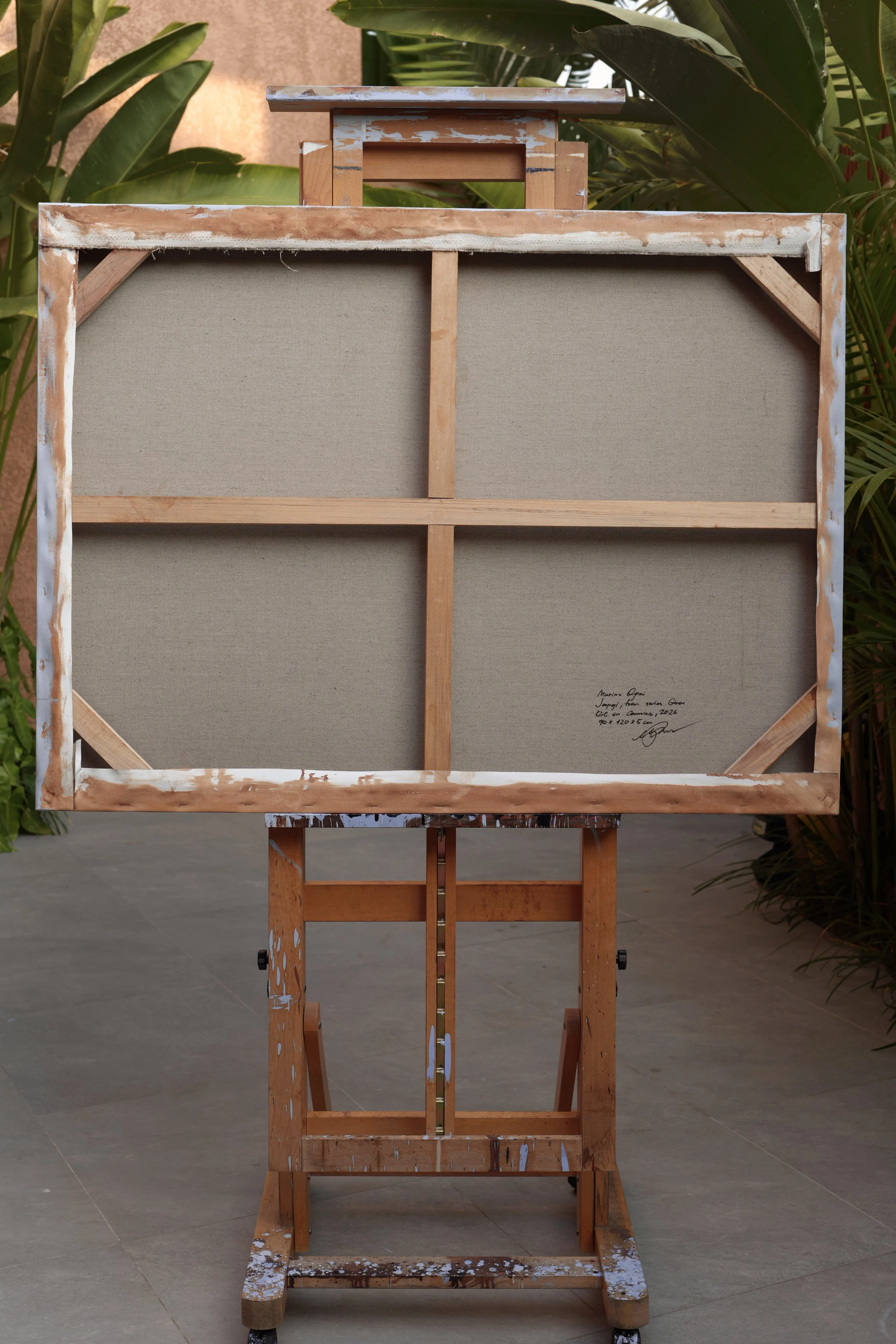 Back of the canvas showing the wooden stretcher with crossbar and handwritten signature, Jeopgi by Marina Ogai