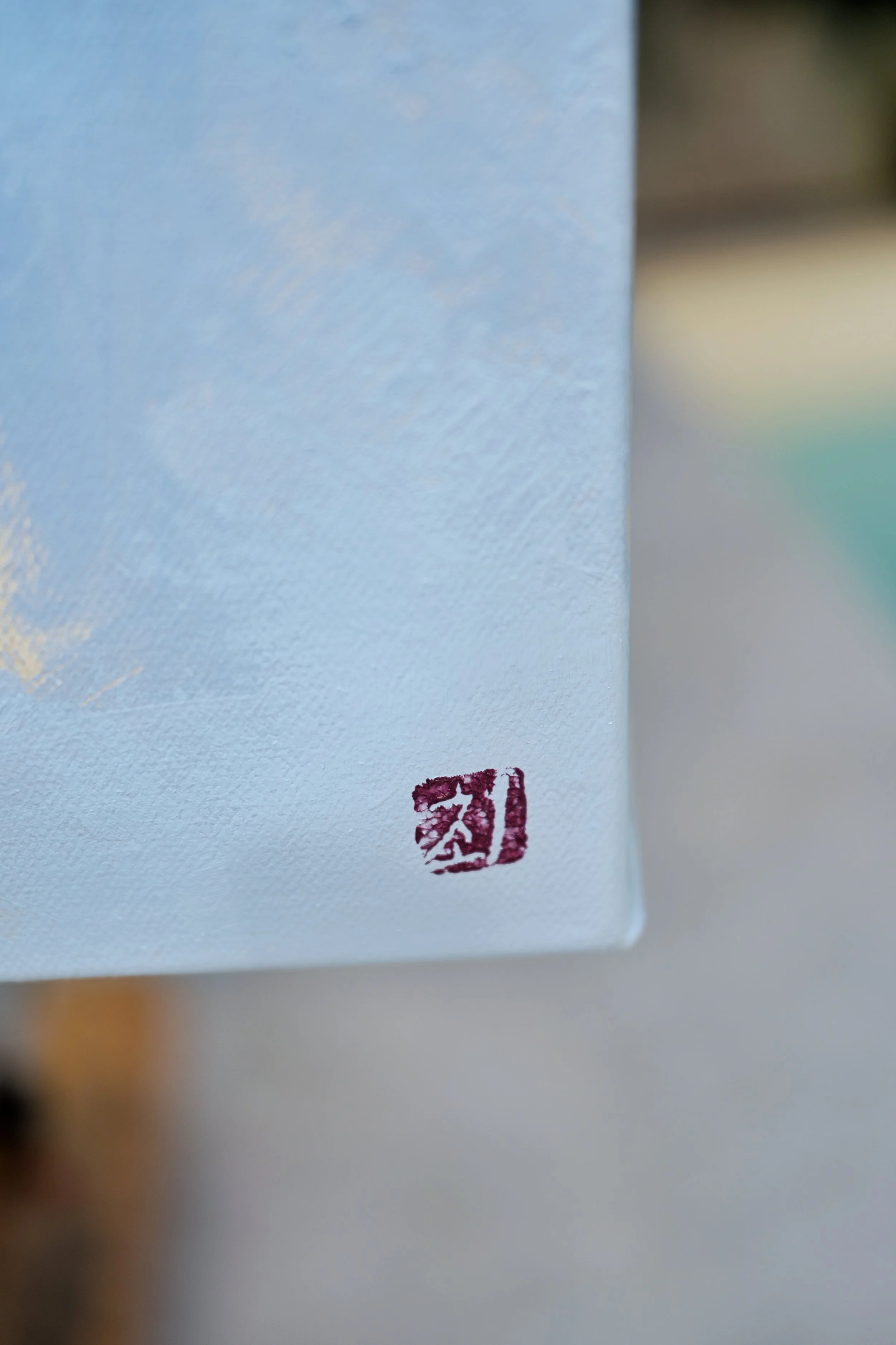 4. Red artist's seal stamped in the corner of the raw canvas edge, signature detail of Ground, oil on canvas by Marina Ogai