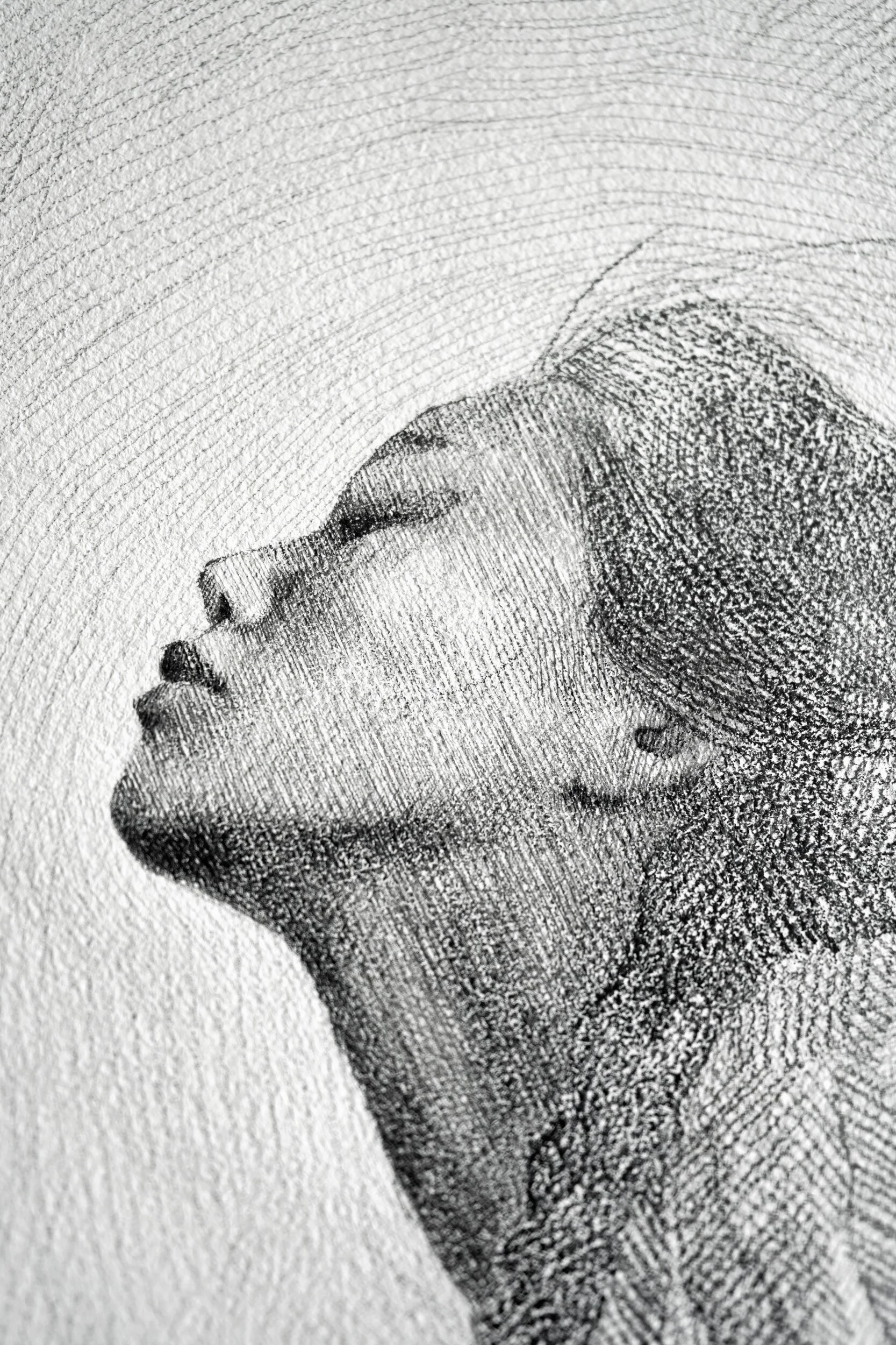 Detail of Fullness by Marina Ogai: close-up of the raised face in profile, eyes closed, pencil on paper