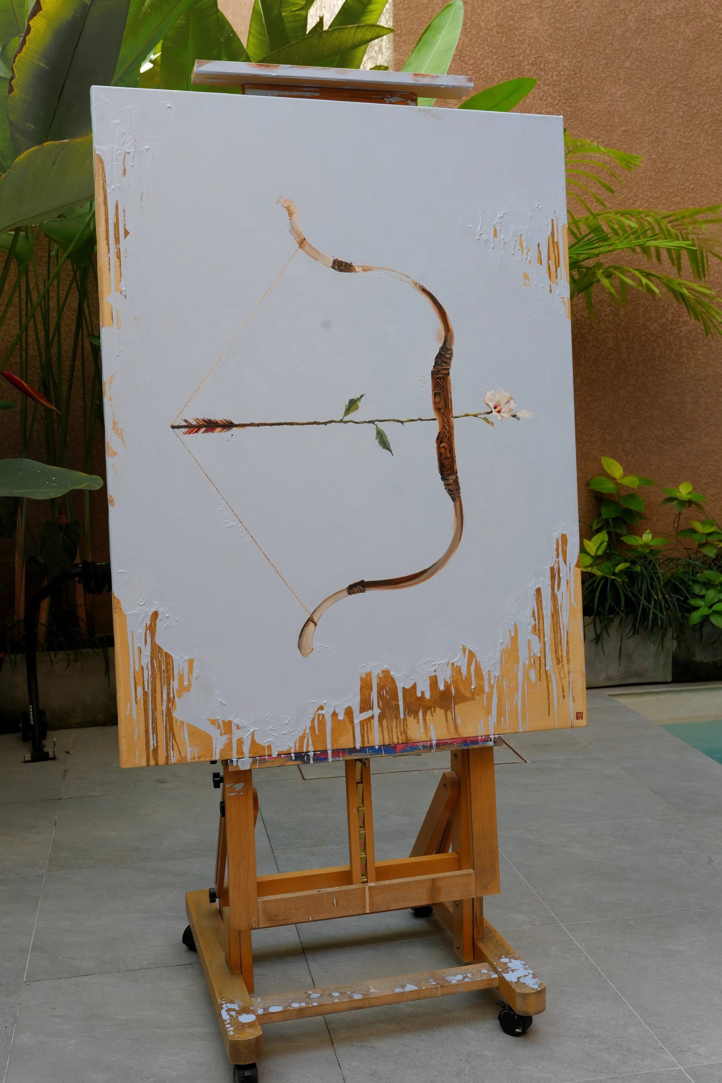 Large oil painting of a bow and flowering arrow on an easel outdoors, 120 × 90 cm, by Marina Ogai