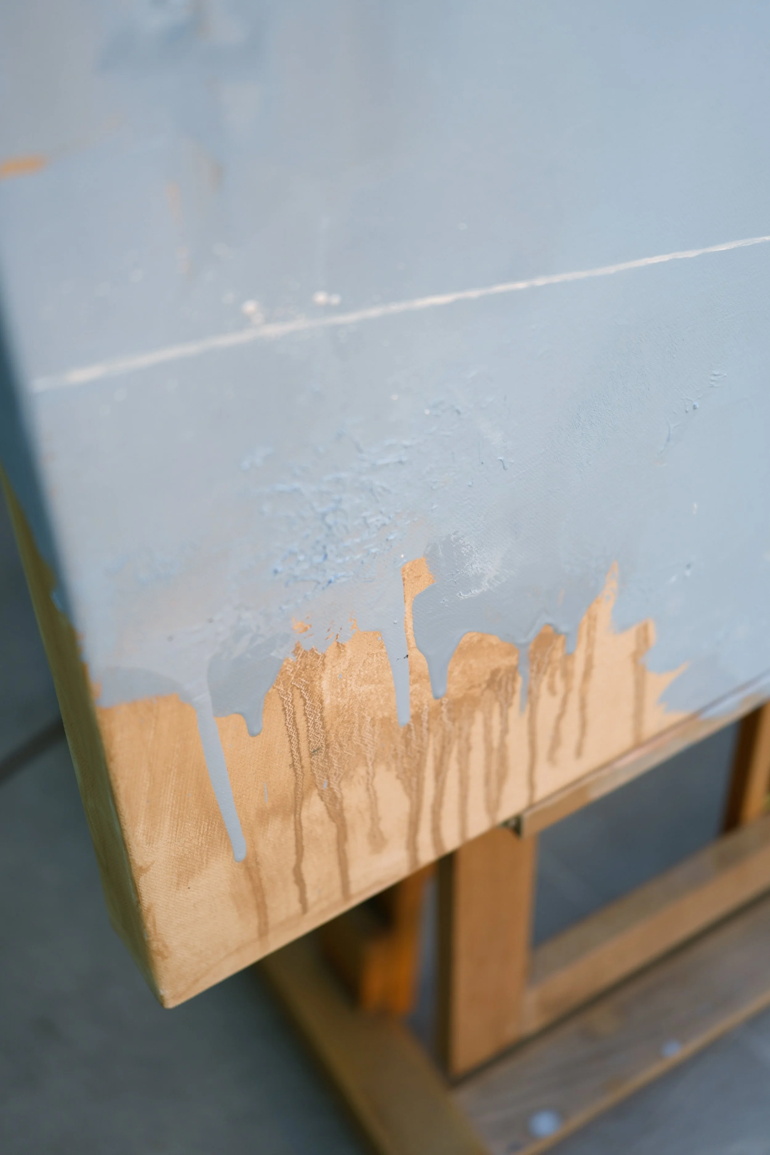 9. Scraped ochre and pale blue paint at the lower edge of the canvas, surface texture of Ground by Marina Ogai