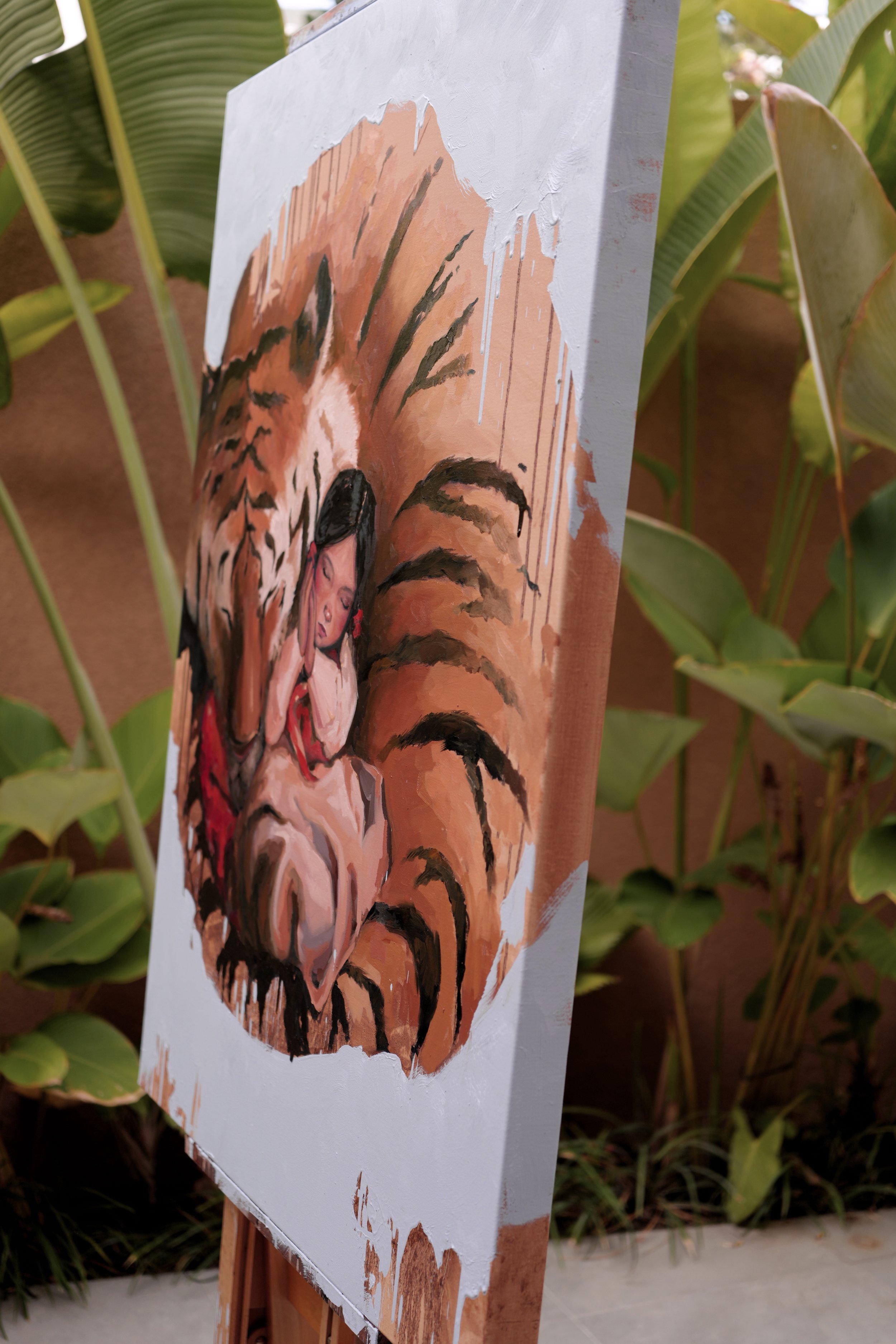A girl in a white hanbok sleeps with her cheek on folded hands, curled inside the body of a giant resting tiger, oil on linen, from Given by Marina Ogai