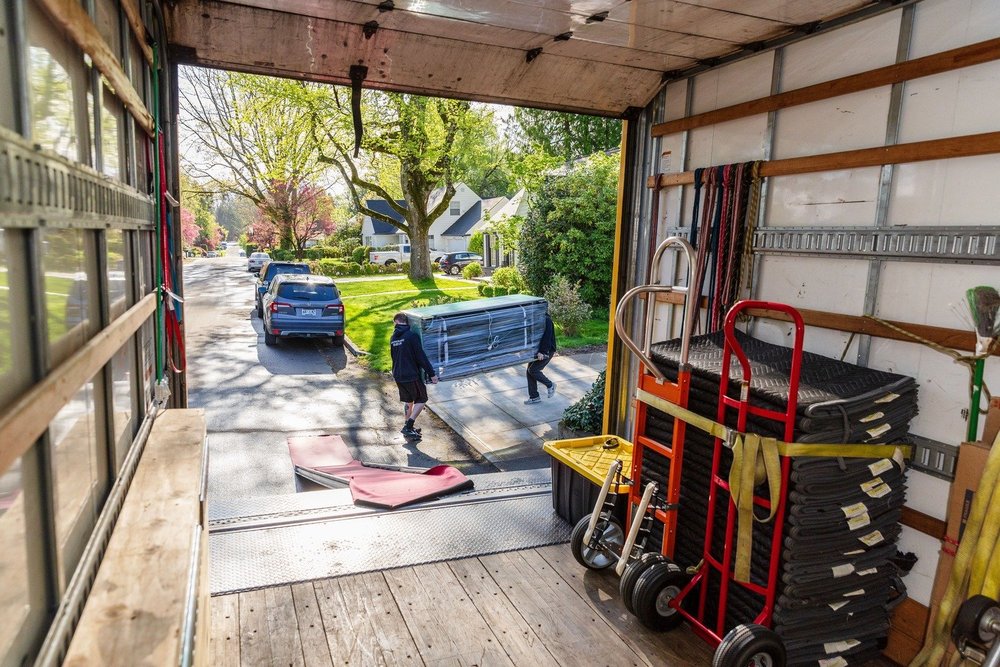 View from inside the truck down the ramp to a tree-lined street, move in Keizer