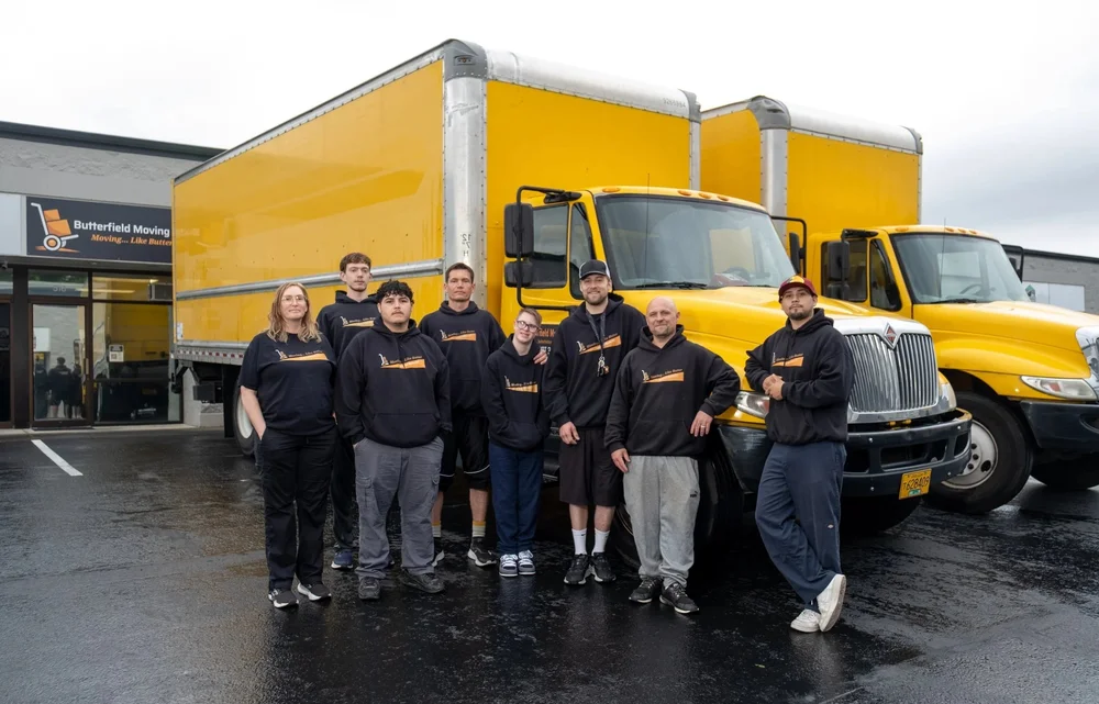 Butterfield crew lined up in front of trucks on a wet morning, office relocation in Tualatin