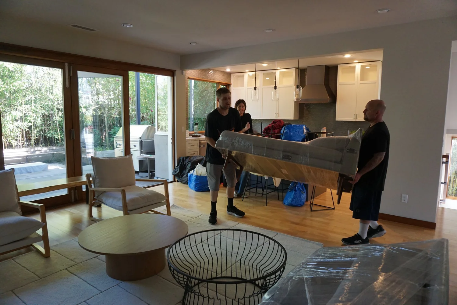 Movers carrying a couch through a living room, senior move in Portland