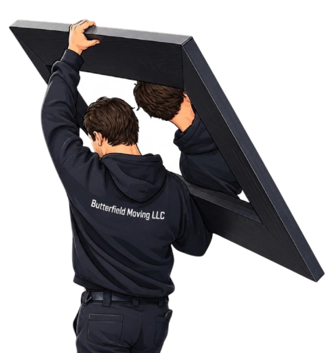 Two movers in dark clothing lift a large flat-panel piece of furniture, with one holding the top and the other supporting the bottom.
