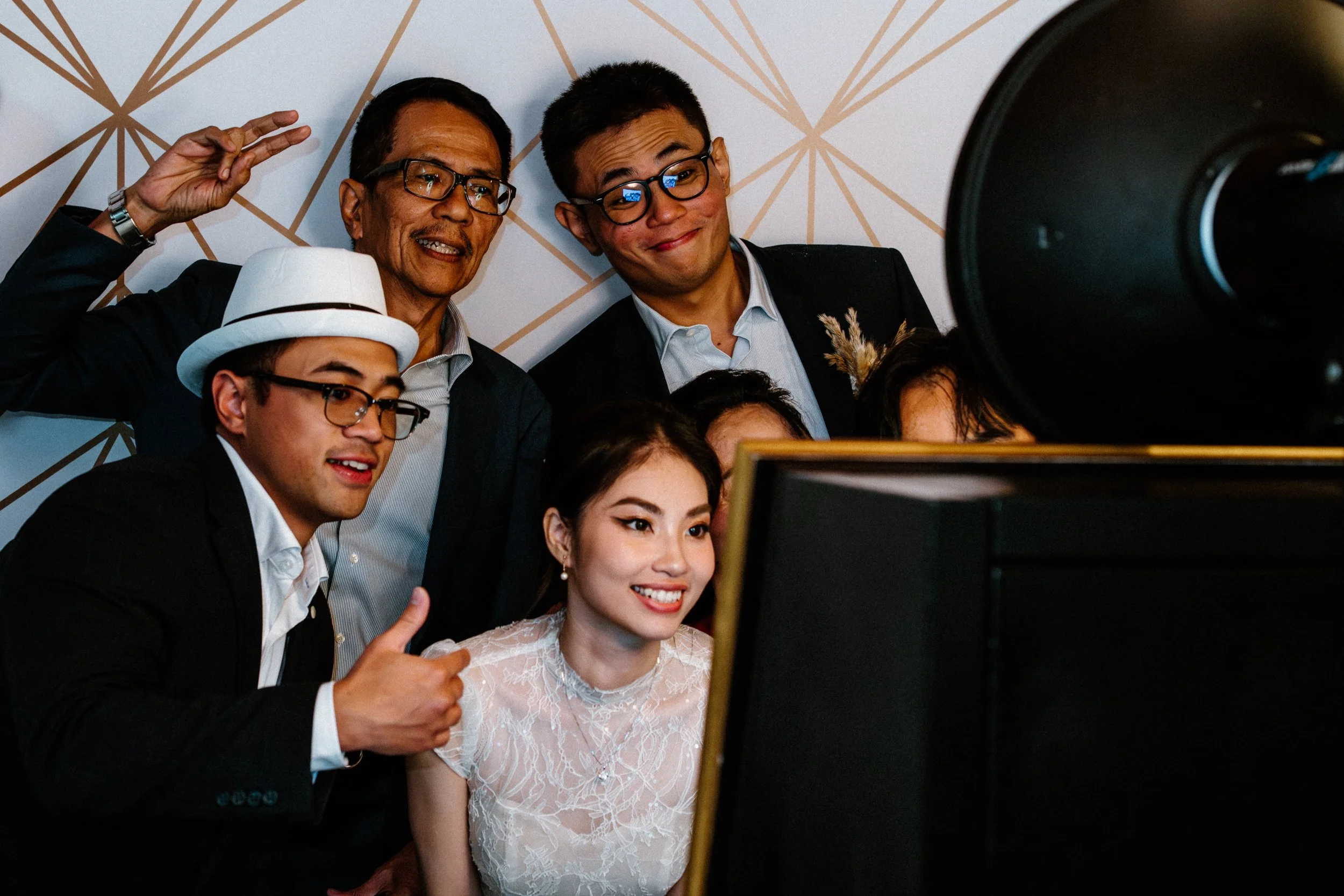 Group of six diverse people taking a group selfie, smiling and looking at a camera.