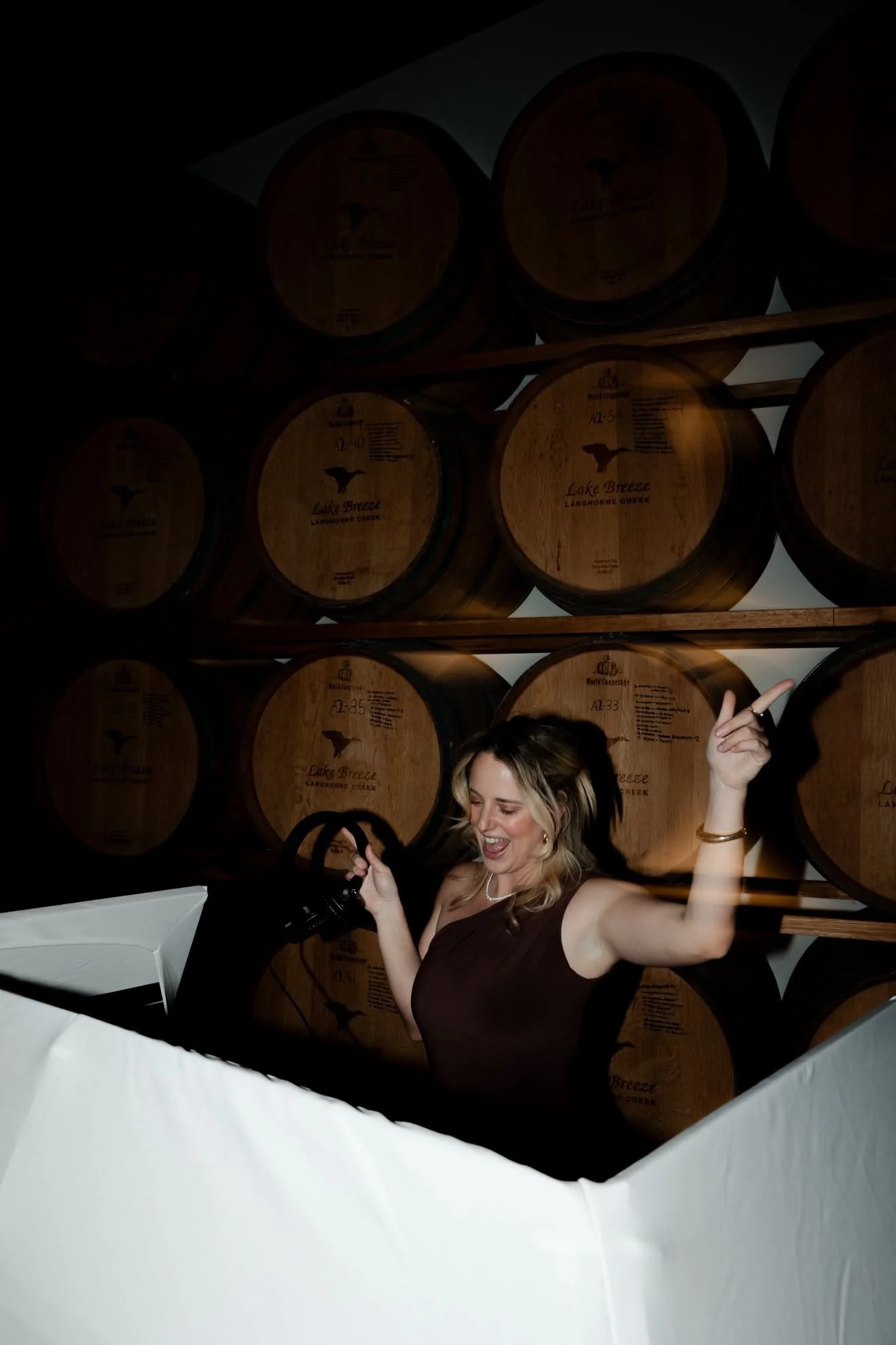 A woman dancing as she Dj's a wedding at Lake Breeze Winery.