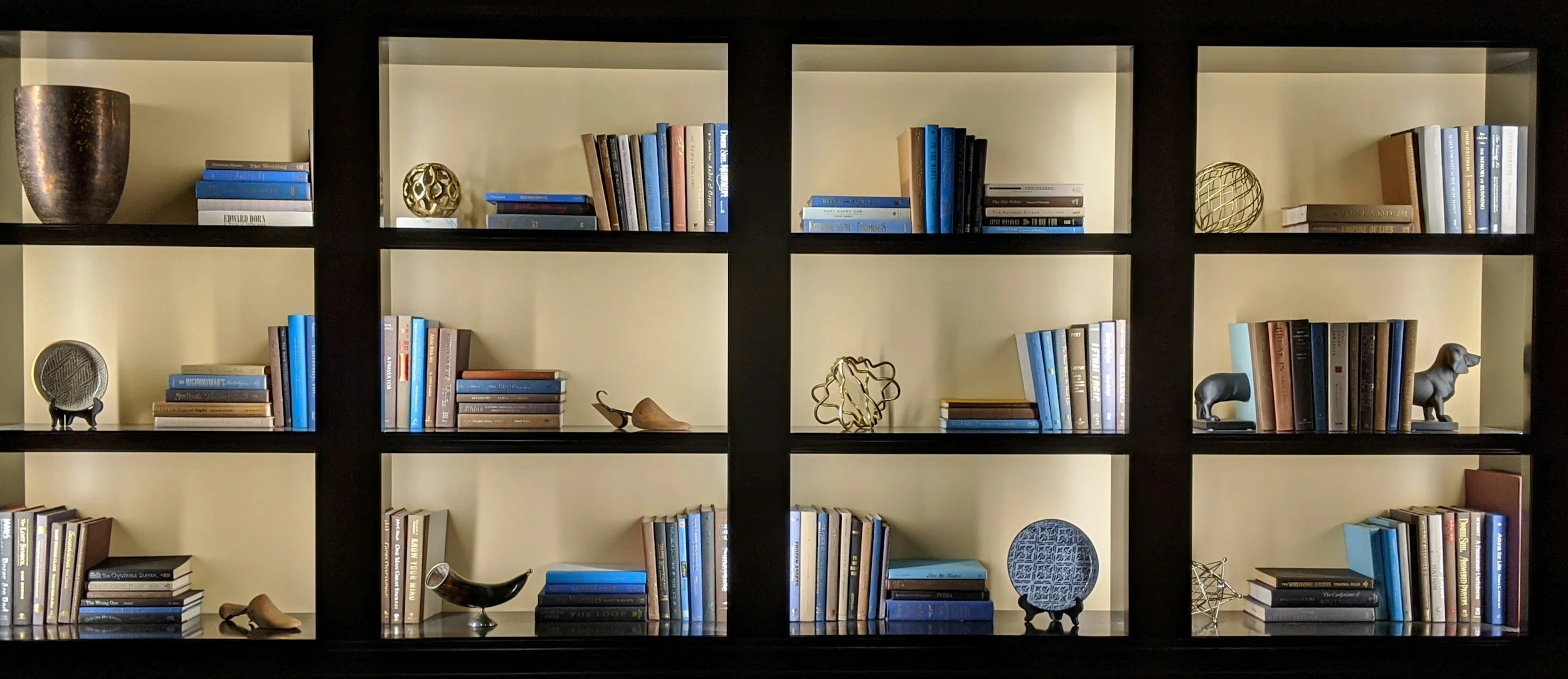 Organized bookshelf with neatly arranged books and décor