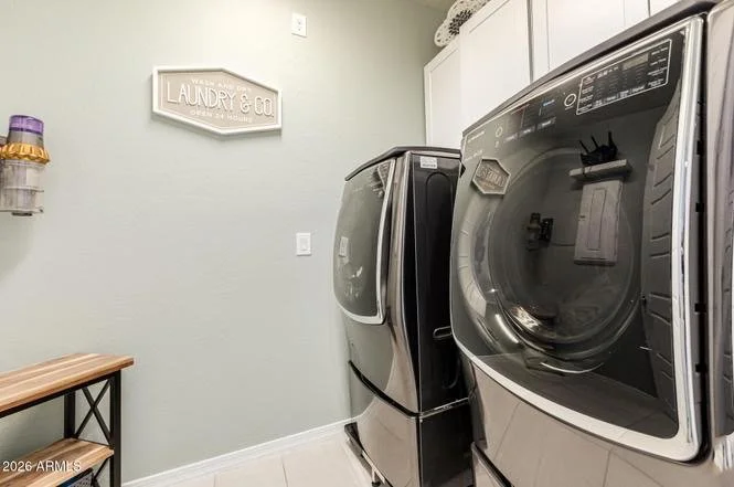 Clean, organized laundry room with modern washer and dryer