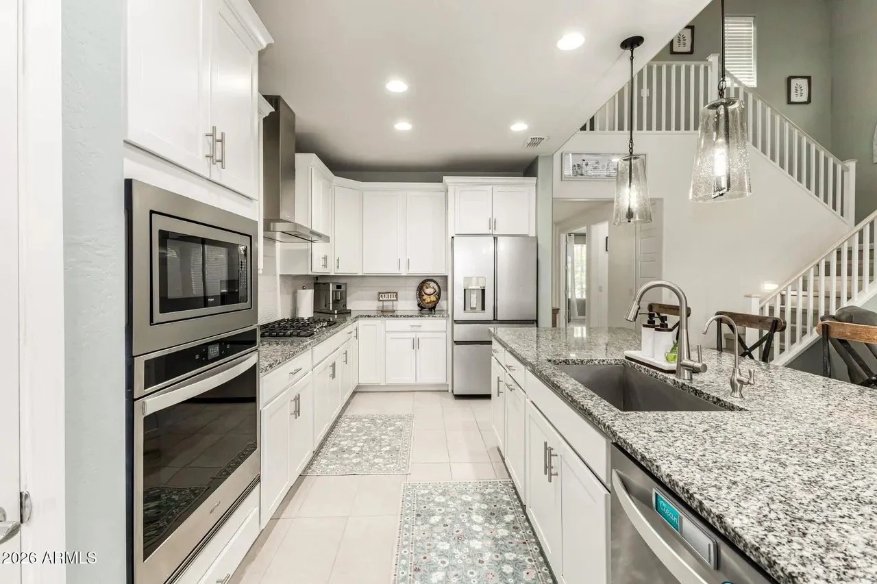 Clean residential kitchen with granite counters and stainless steel appliances