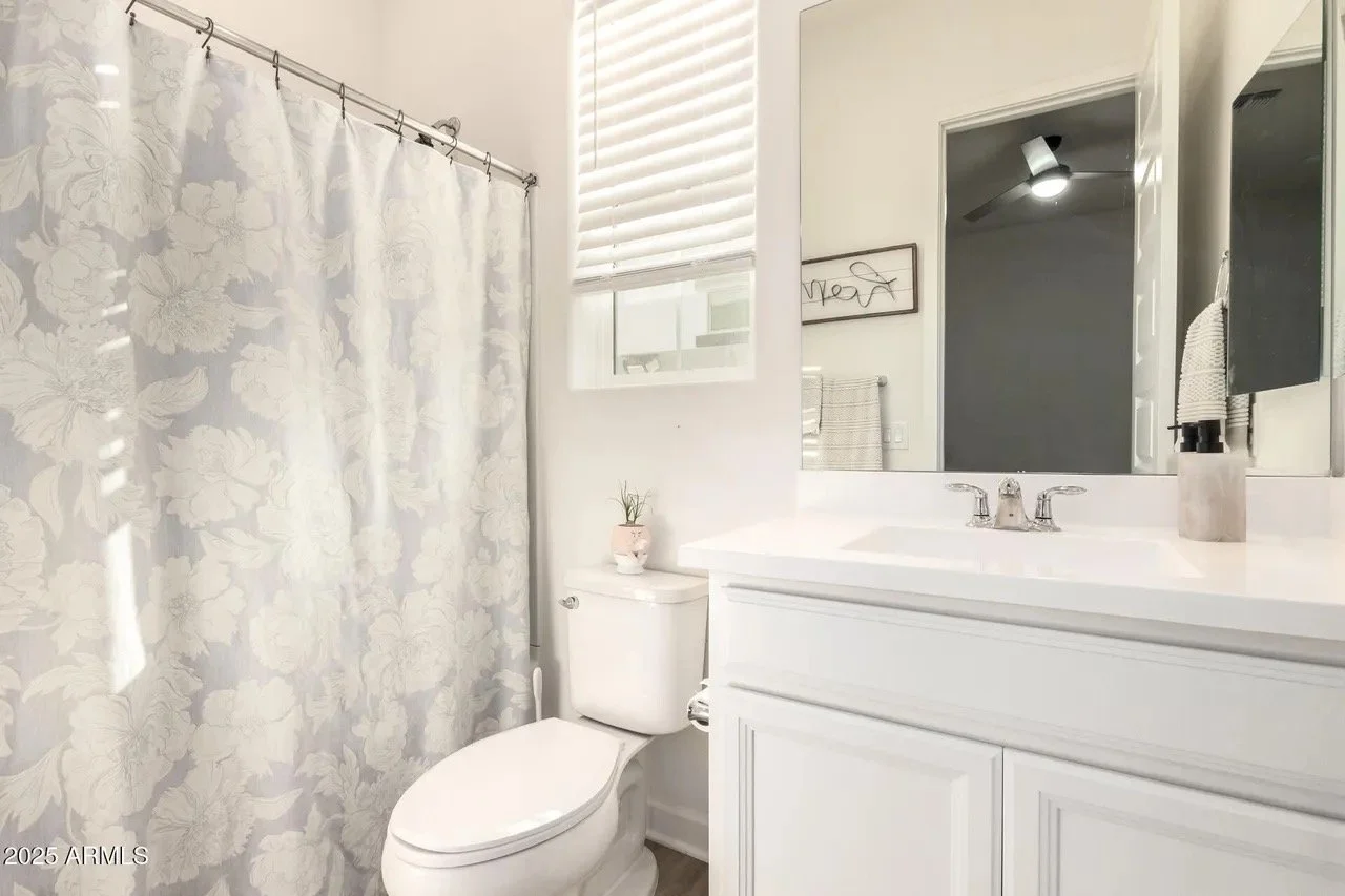 Clean residential bathroom with polished vanity and tidy fixtures